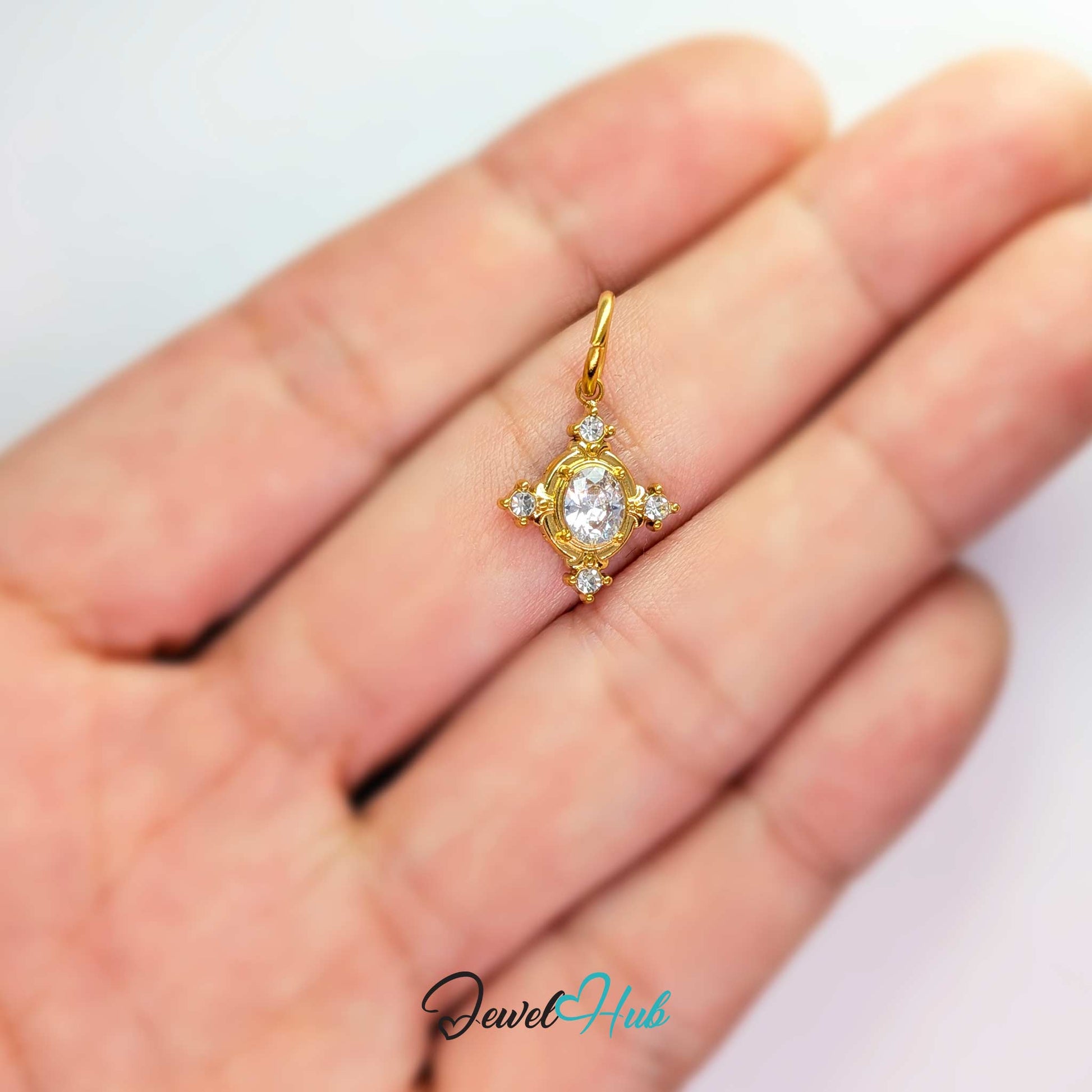 Gem Star charm, gold stainless steel, held in the hand to show its size - JewelHub