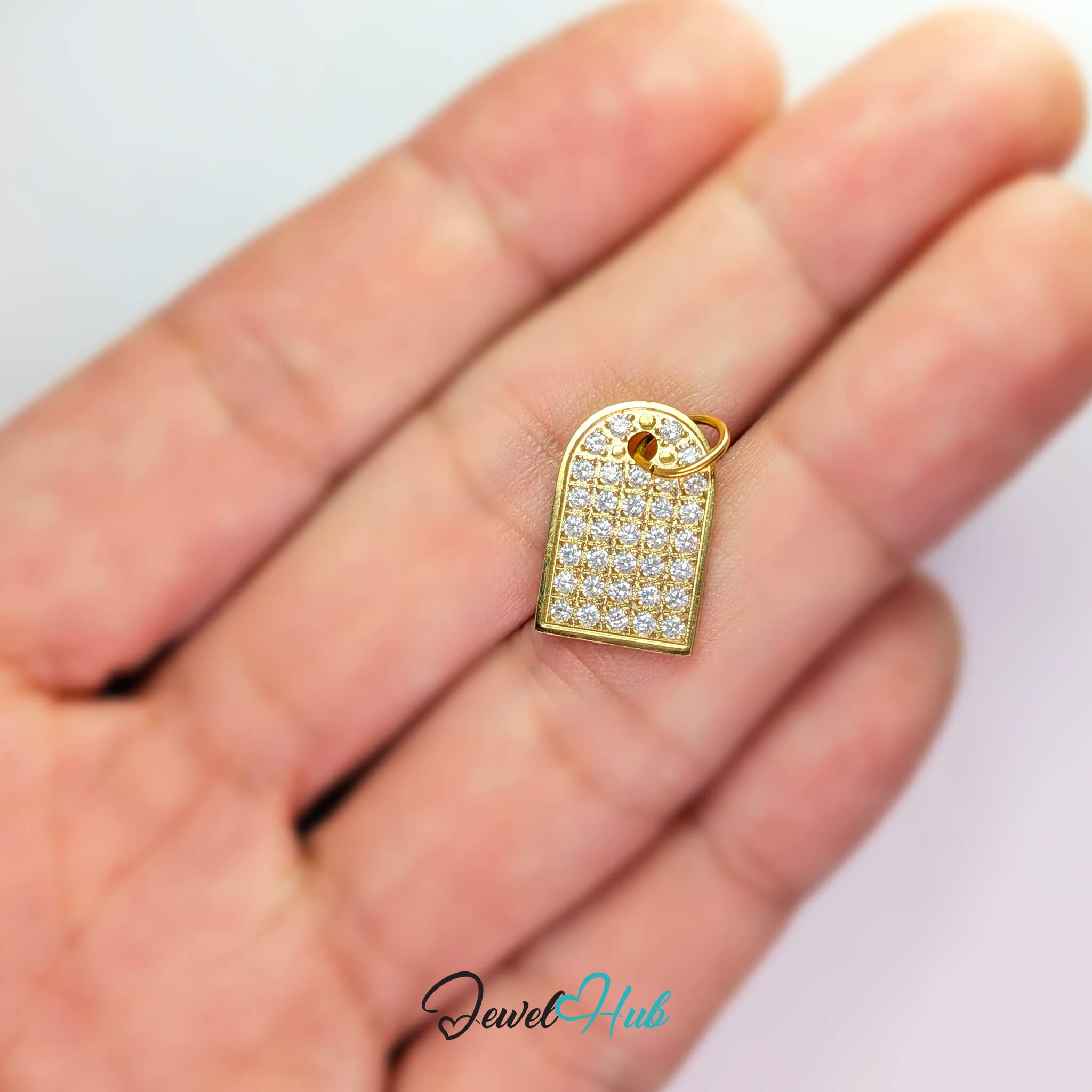 Pave Arch charm, gold stainless steel, held in the hand to show its size - JewelHub