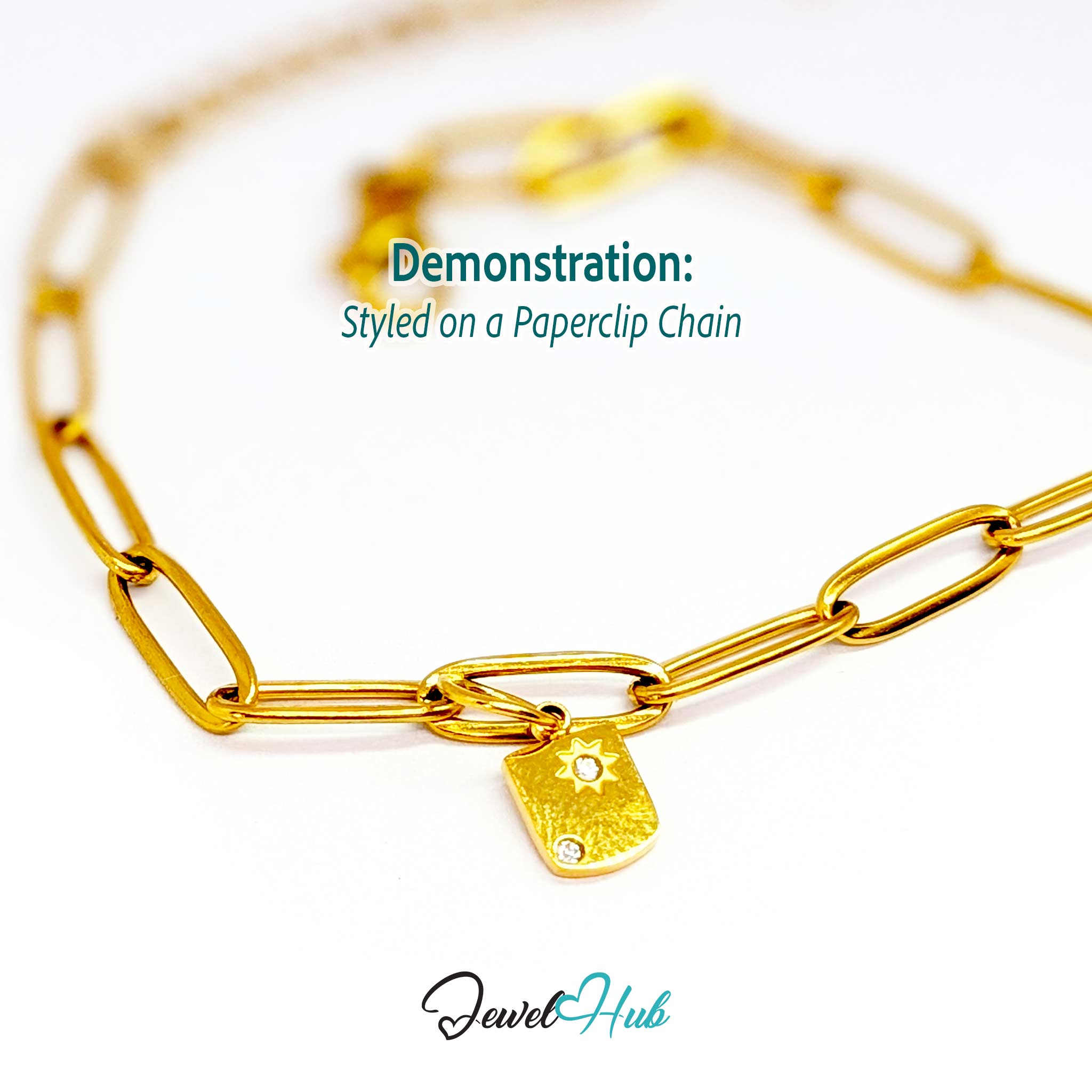 Mini Star Shield charm, gold stainless steel, styled on a gold paperclip chain bracelet - JewelHub
