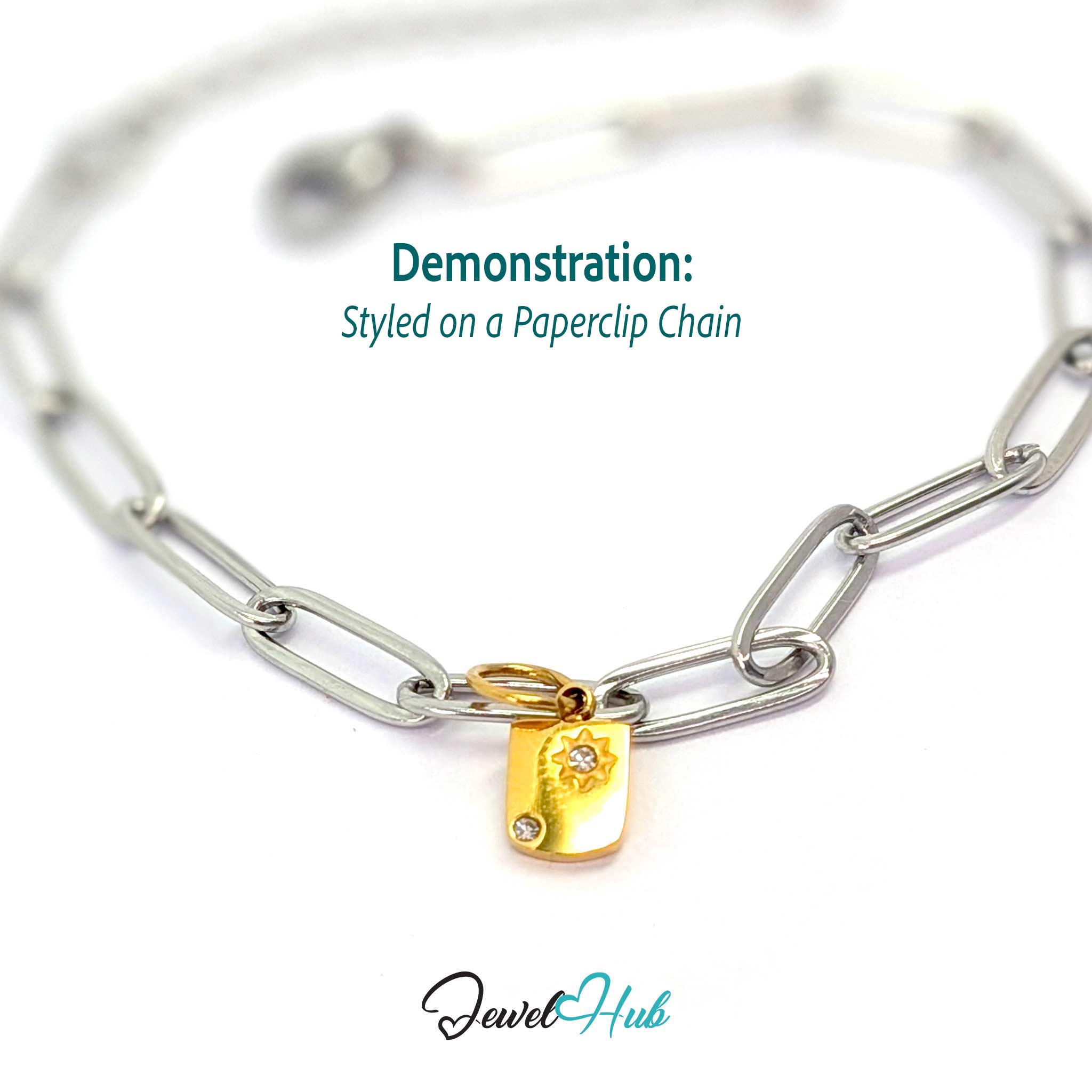 Mini Star Shield charm, gold stainless steel, styled on a silver paperclip chain bracelet - JewelHub
