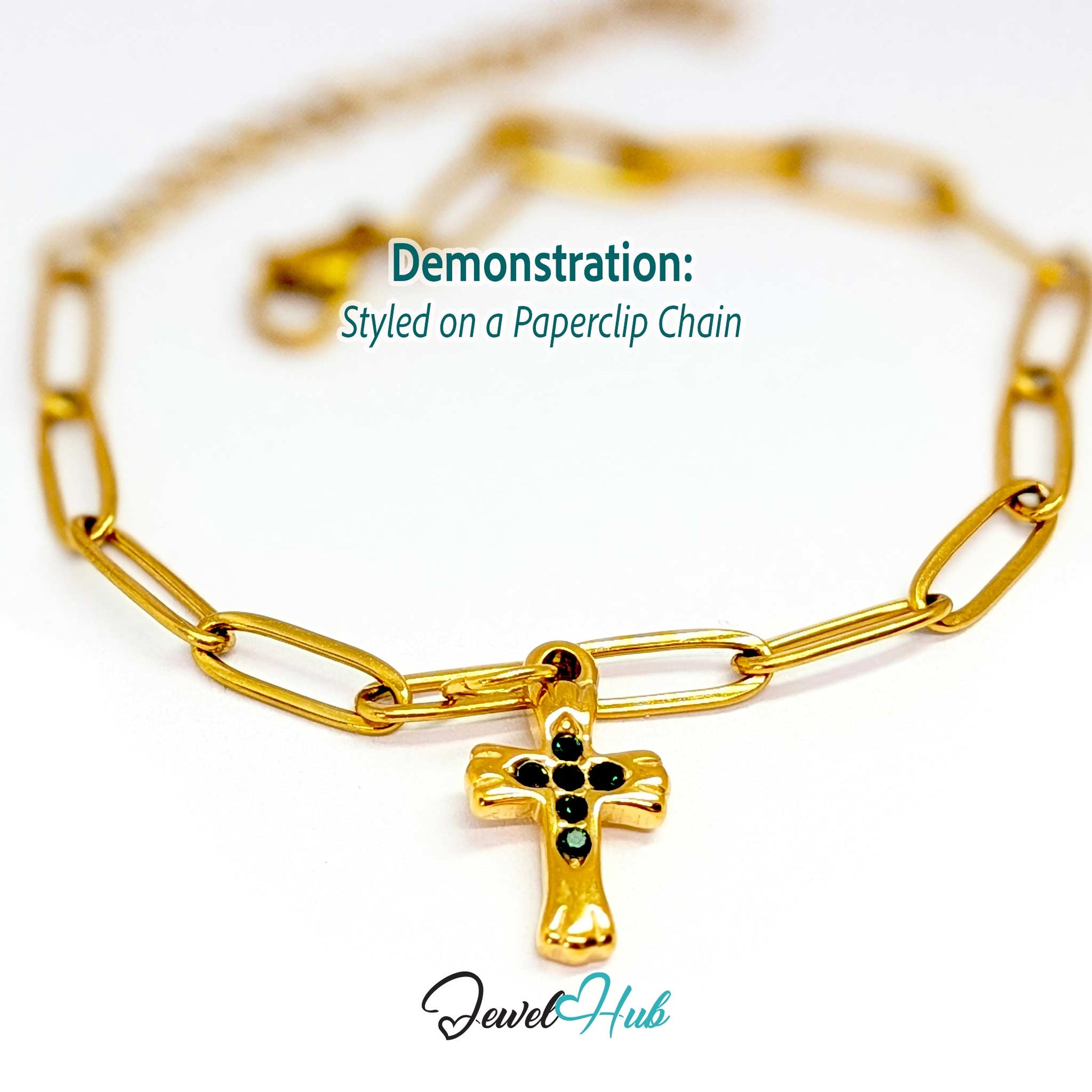 Small cross charm in gold stainless steel with six green stones - styled on a gold paperclip chain bracelet - JewelHub
