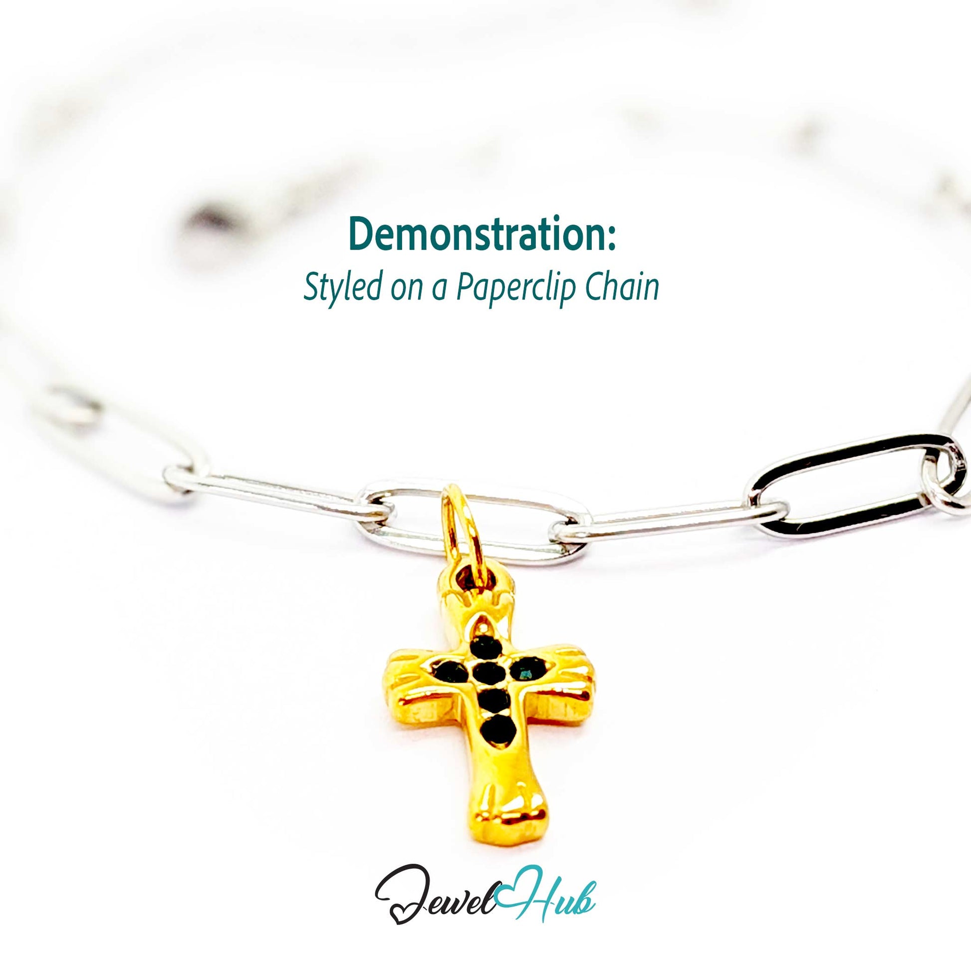 Small cross charm in gold stainless steel with six green stones - styled on a silver paperclip chain bracelet - JewelHub