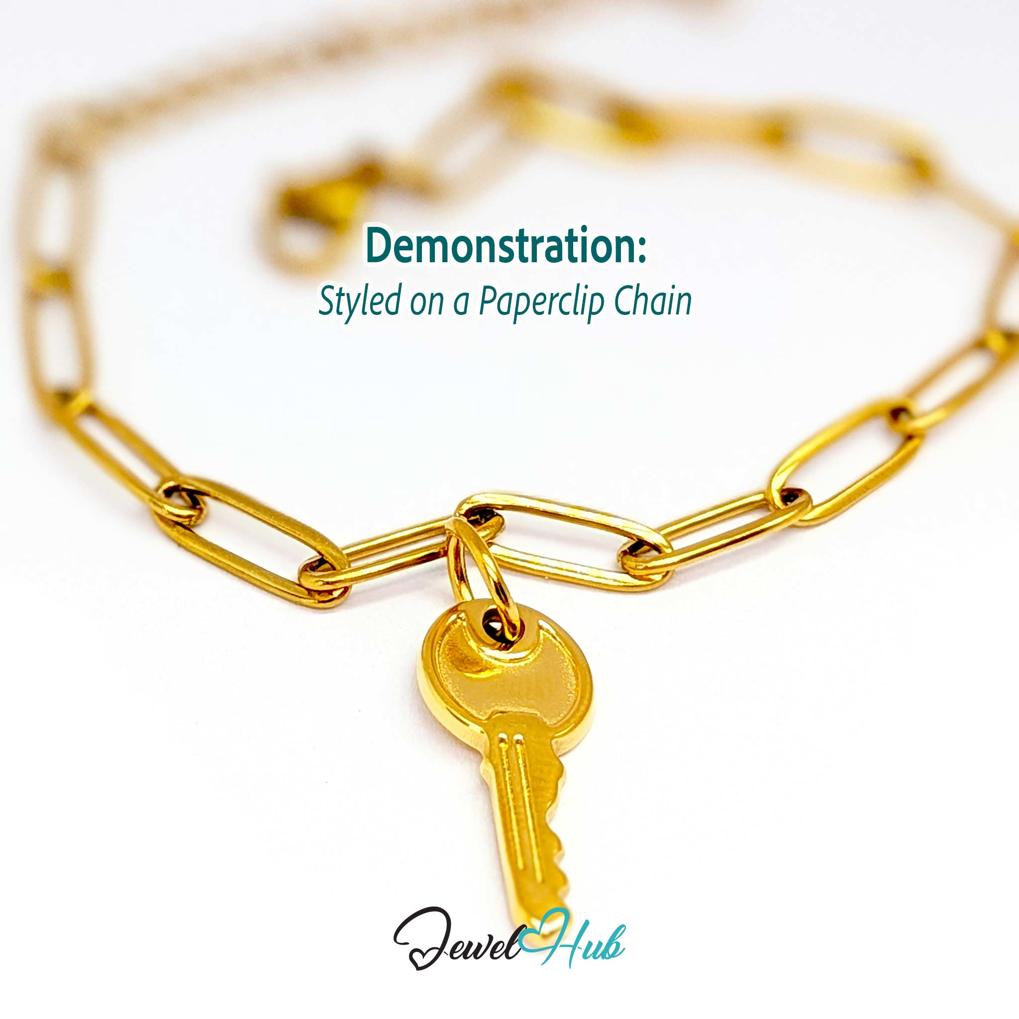 Everyday key charm in gold stainless steel with a plain round head - styled on a gold paperclip chain bracelet - JewelHub