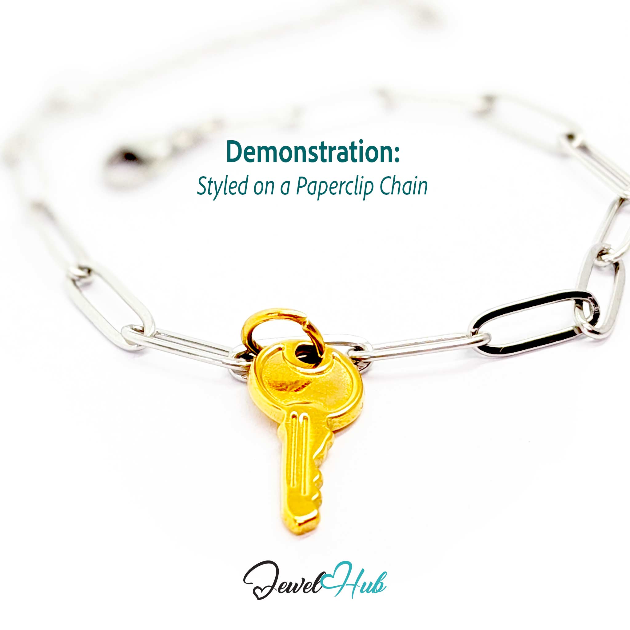 Everyday key charm in gold stainless steel with a plain round head - styled on a silver paperclip chain bracelet - JewelHub