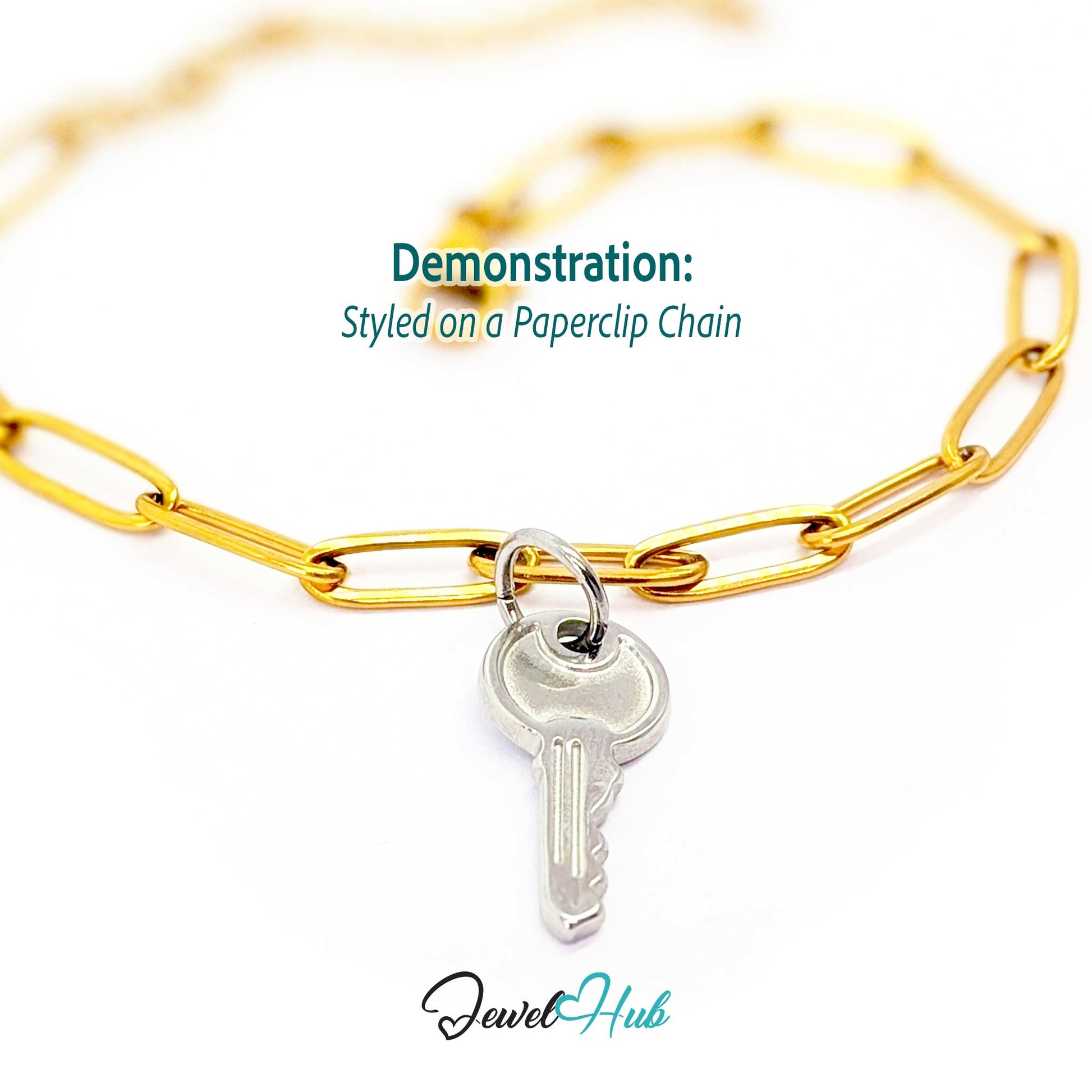 Everyday key charm in silver stainless steel with a plain round head - styled on a gold paperclip chain bracelet - JewelHub