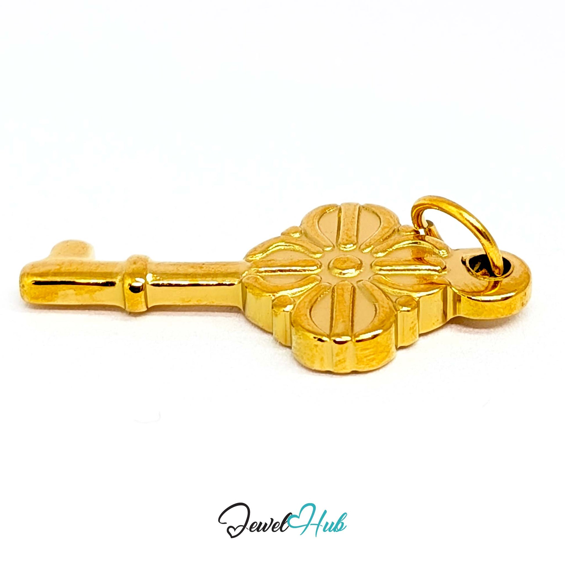 Vintage key charm in gold stainless steel with a quatrefoil bow - turned to show depth - JewelHub