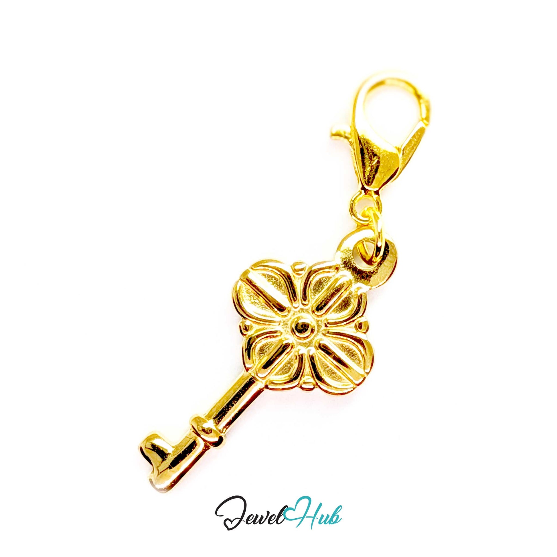 Vintage key charm in gold stainless steel with a quatrefoil bow - shown with the lobster clasp attached - JewelHub