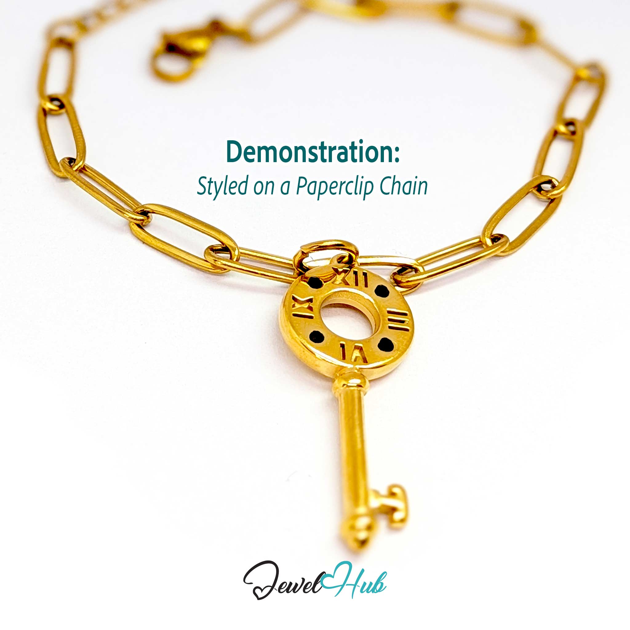 Roman numeral key charm in gold stainless steel with black stones - styled on a gold paperclip chain bracelet - JewelHub