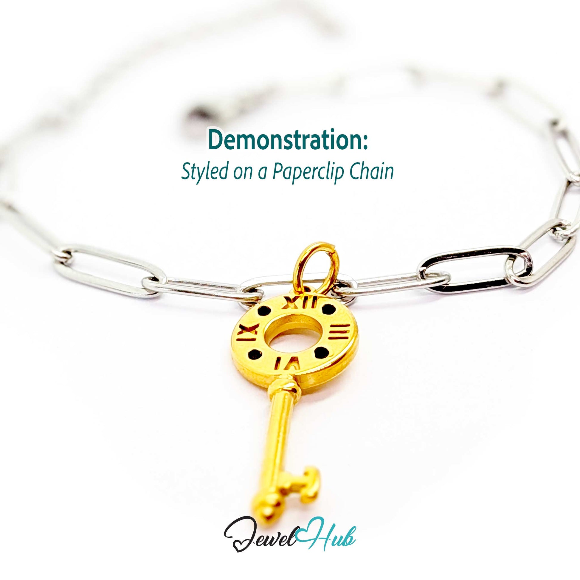 Roman numeral key charm in gold stainless steel with black stones - styled on a silver paperclip chain bracelet - JewelHub