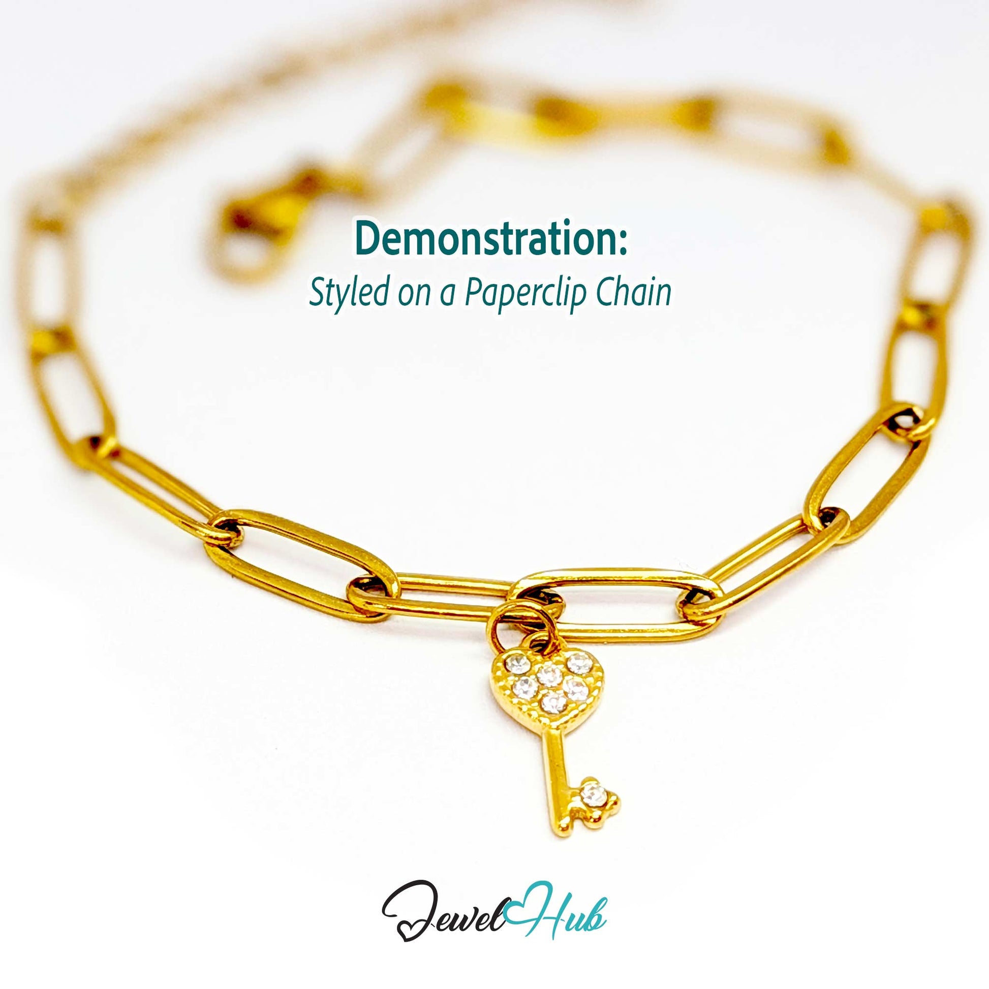 Mini heart key charm in gold stainless steel set with crystals - styled on a gold paperclip chain bracelet - JewelHub
