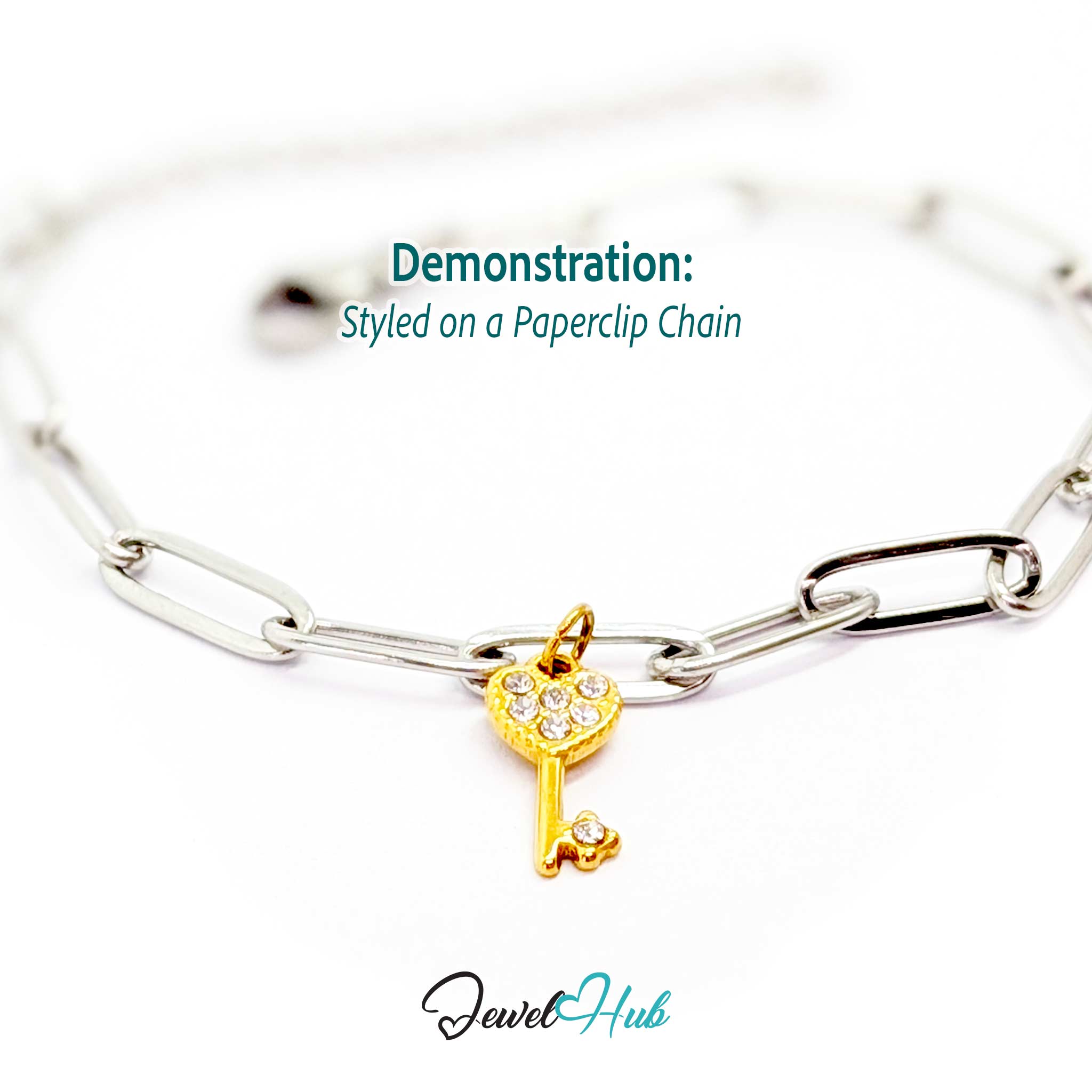 Mini heart key charm in gold stainless steel set with crystals - styled on a silver paperclip chain bracelet - JewelHub