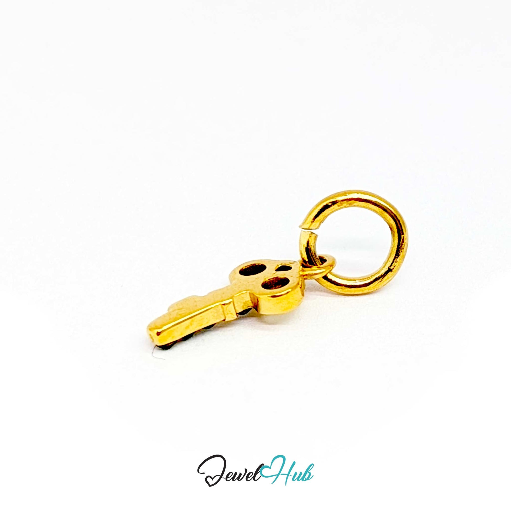 Mini key charm in gold stainless steel with four green stones - turned to show depth - JewelHub