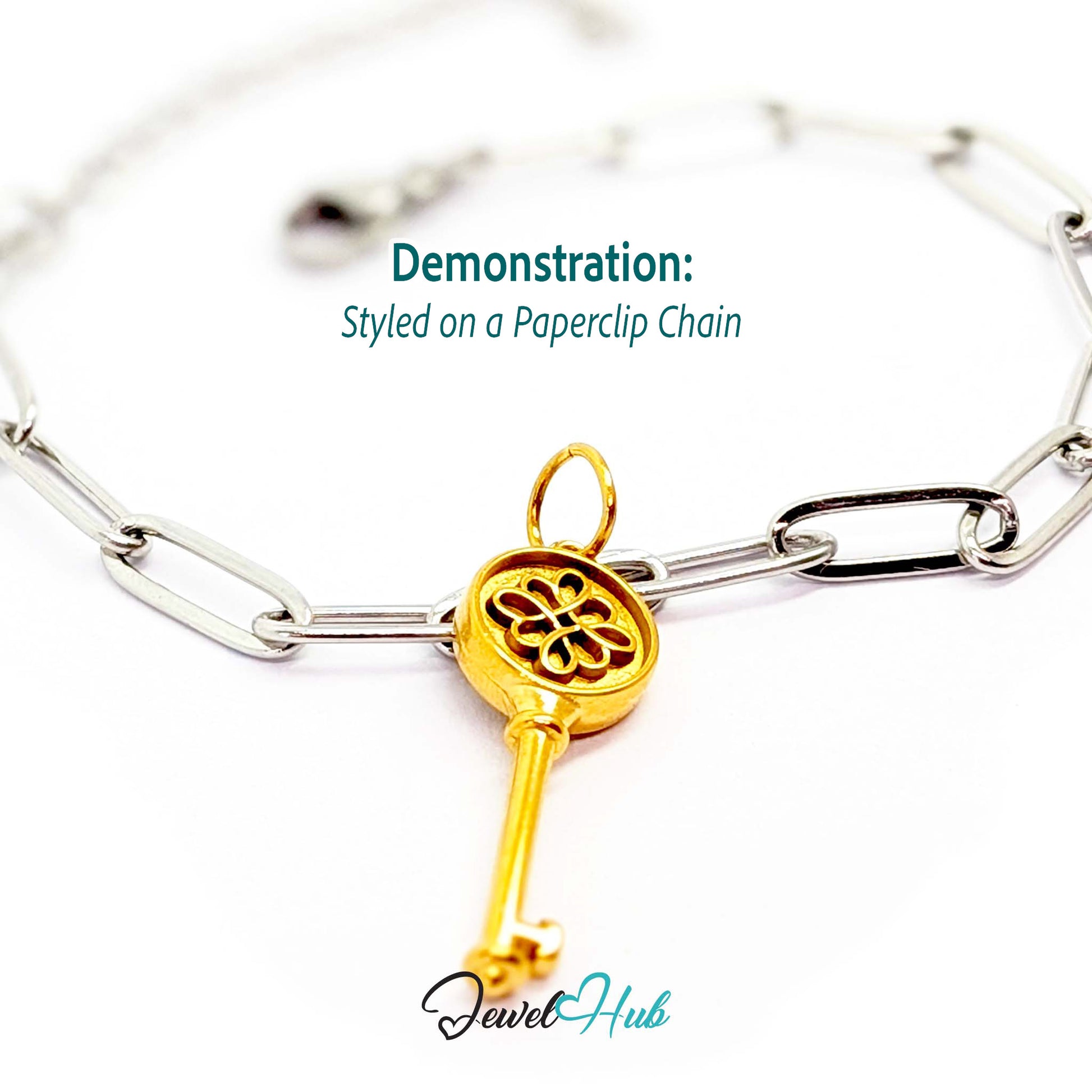 Round openwork key charm in gold stainless steel - styled on a silver paperclip chain bracelet - JewelHub