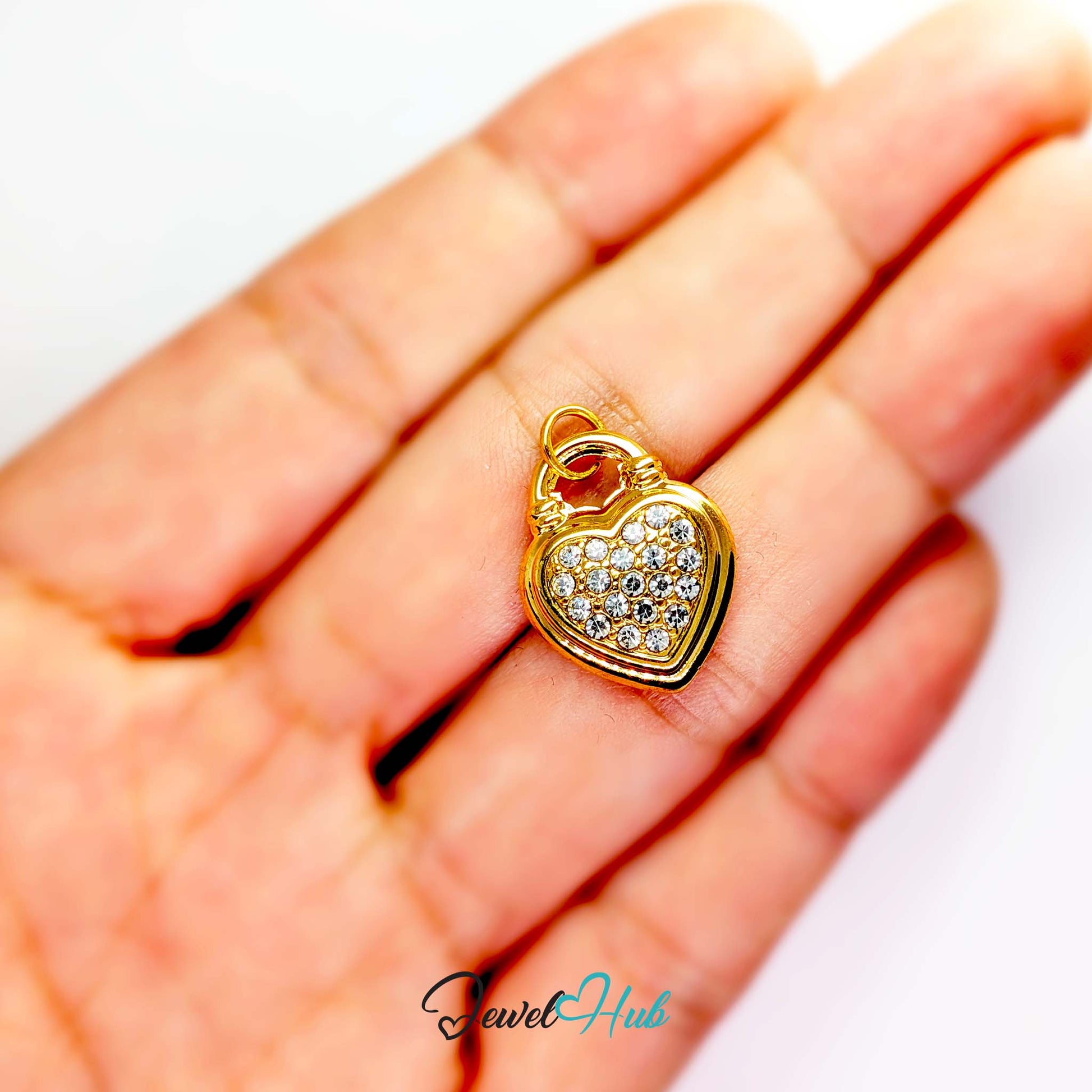 Pave heart padlock charm in gold stainless steel - held in the hand for scale - JewelHub