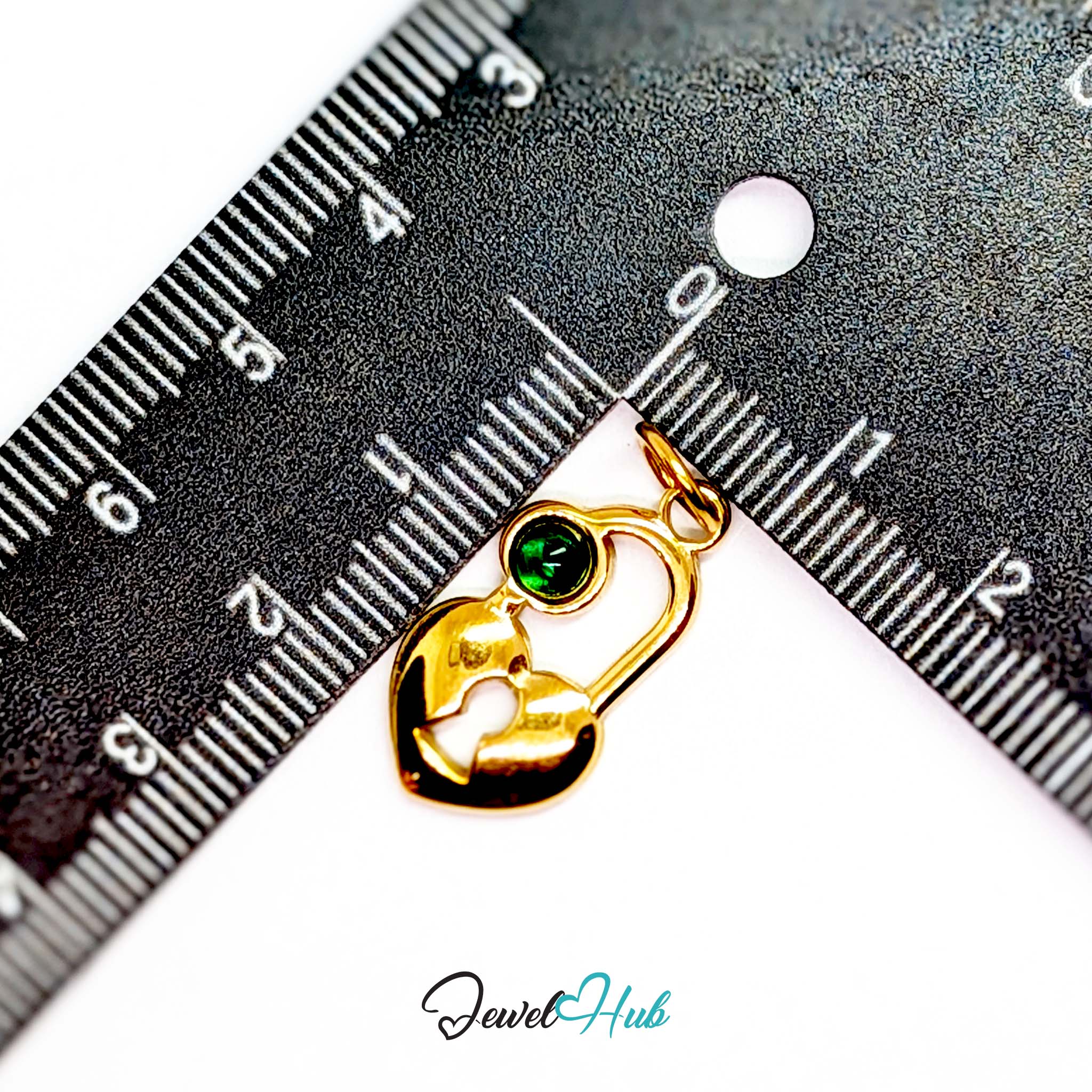 Green stone heart lock charm in gold stainless steel - beside a ruler for scale - JewelHub