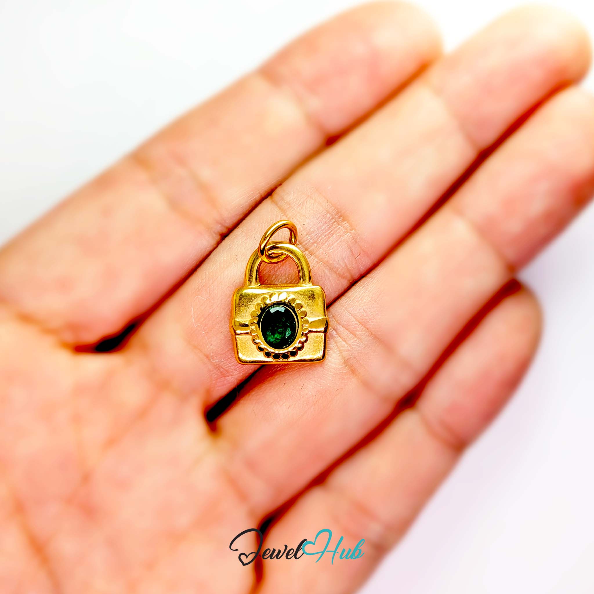 Green stone padlock charm in gold stainless steel - held in the hand for scale - JewelHub