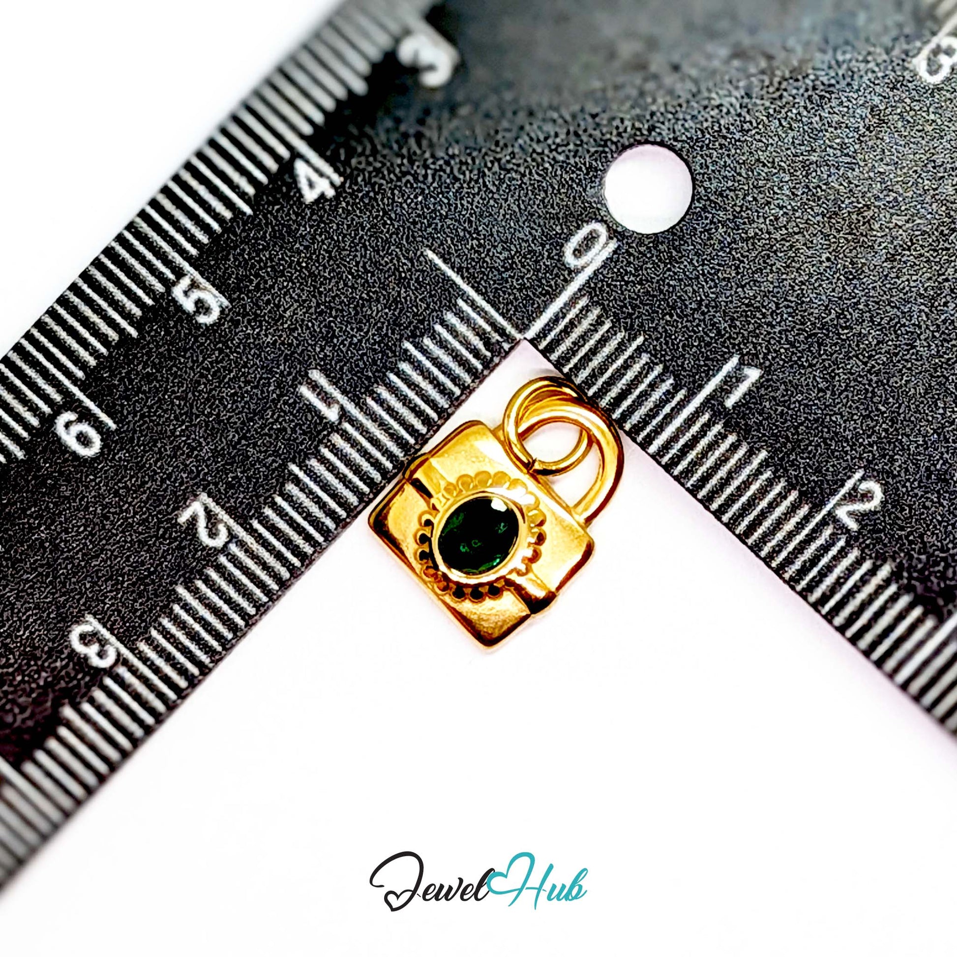 Green stone padlock charm in gold stainless steel - beside a ruler for scale - JewelHub