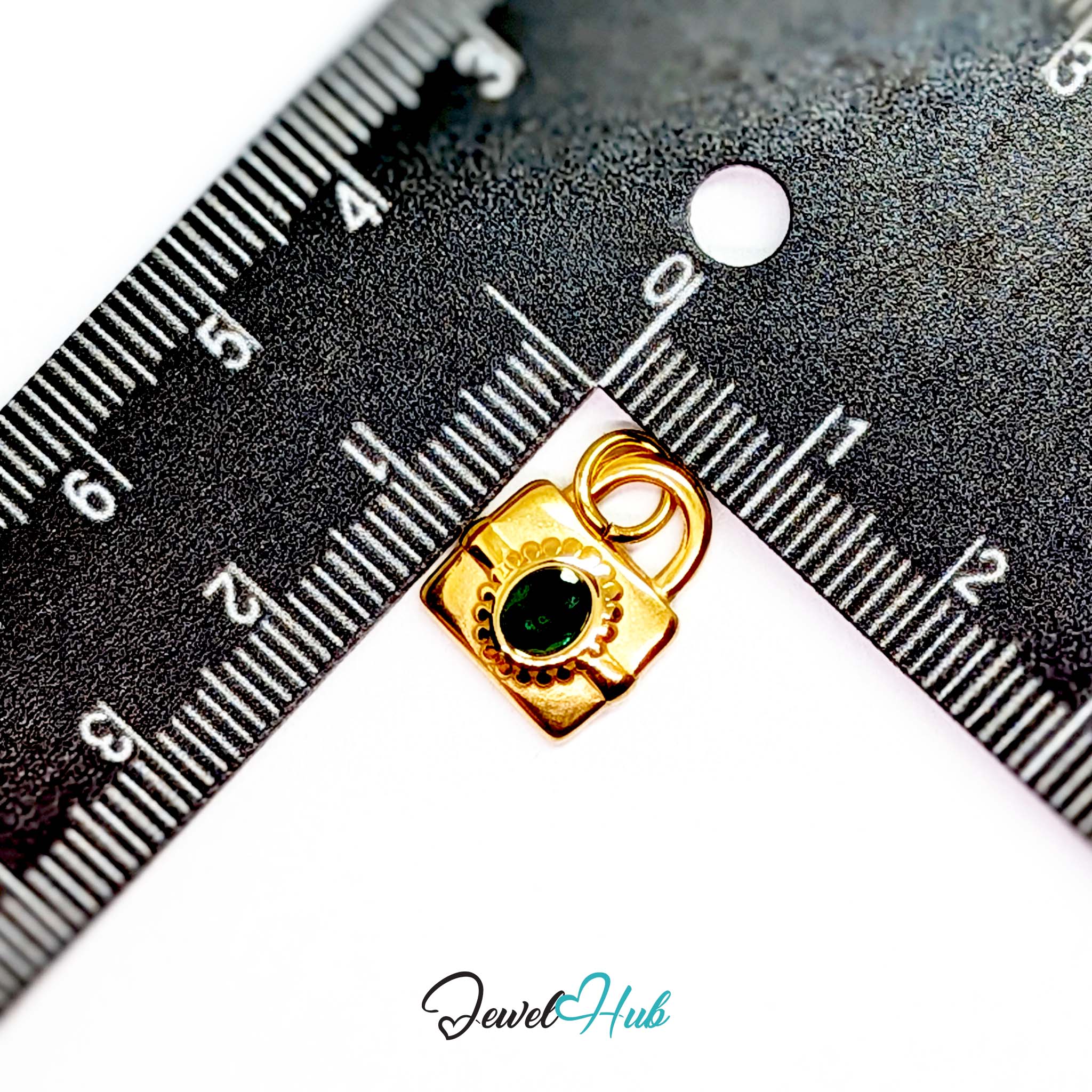 Green stone padlock charm in gold stainless steel - beside a ruler for scale - JewelHub