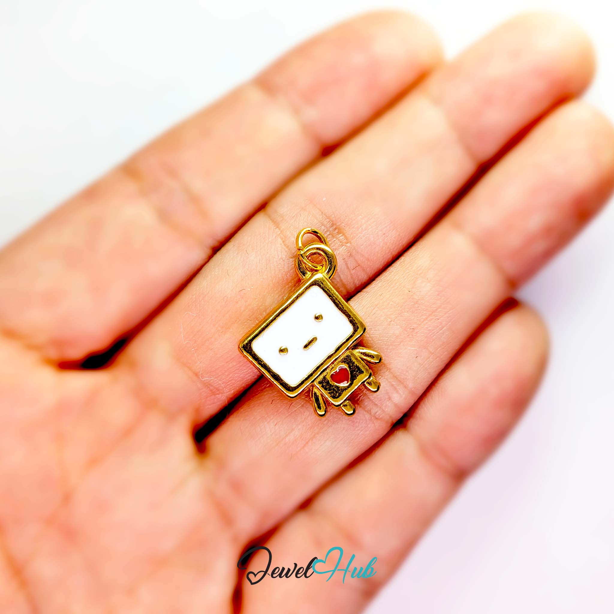 Enamel TV robot charm in gold stainless steel - held in the hand for scale - JewelHub