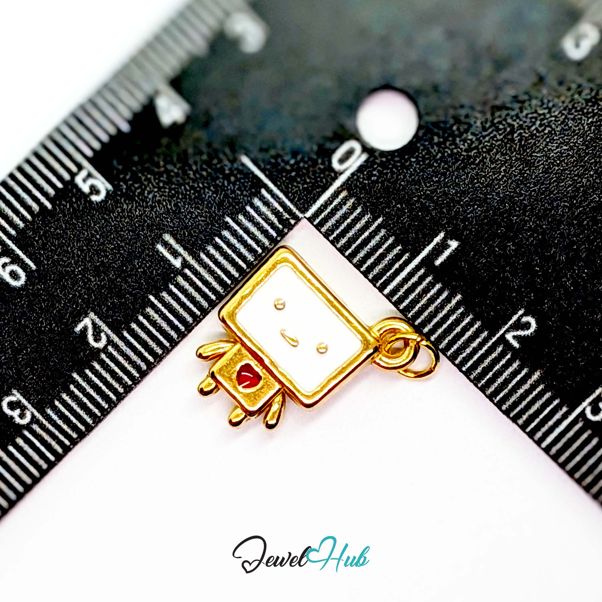 Enamel TV robot charm in gold stainless steel - beside a ruler for scale - JewelHub