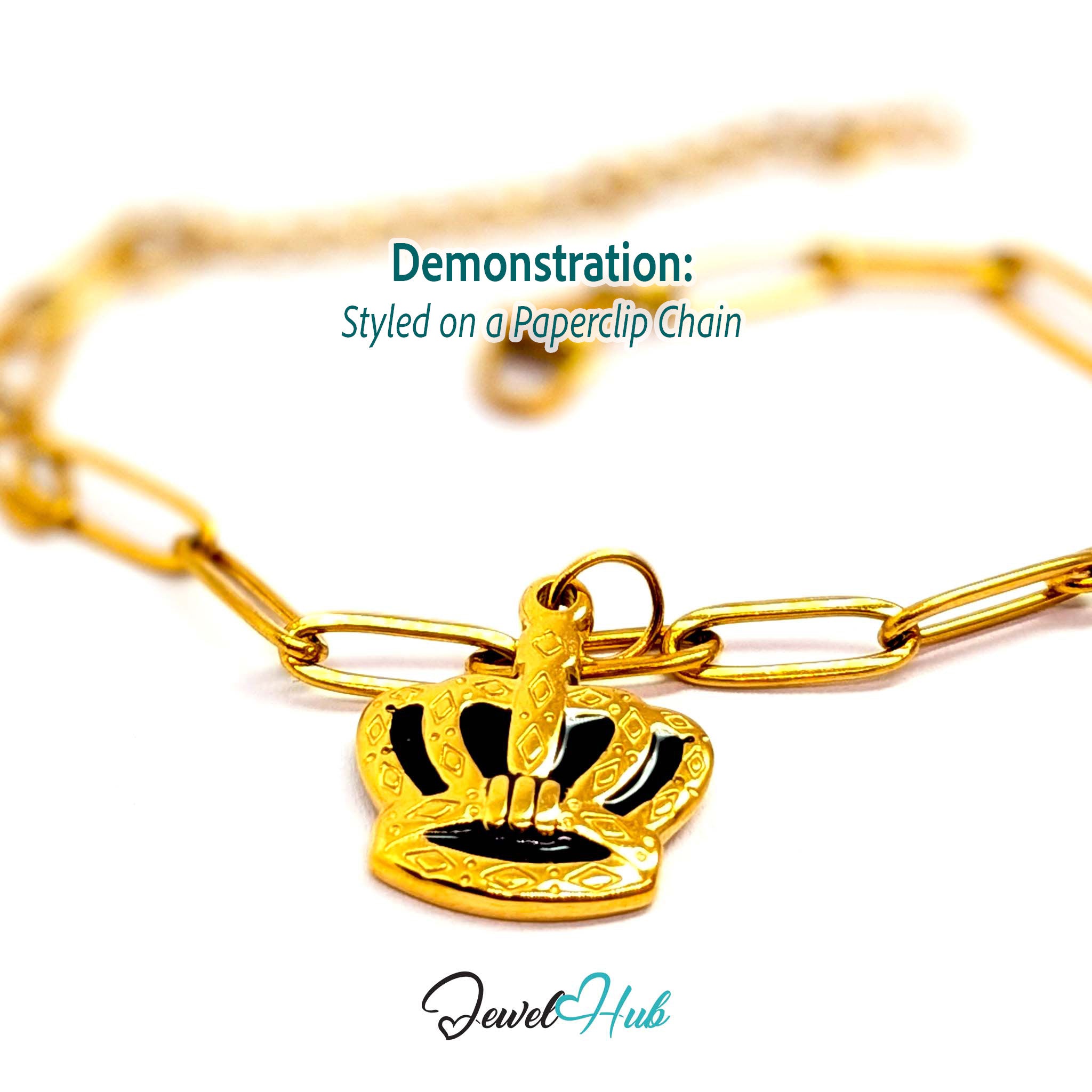 Crown charm in gold stainless steel with black enamel - styled on a gold paperclip chain bracelet - JewelHub