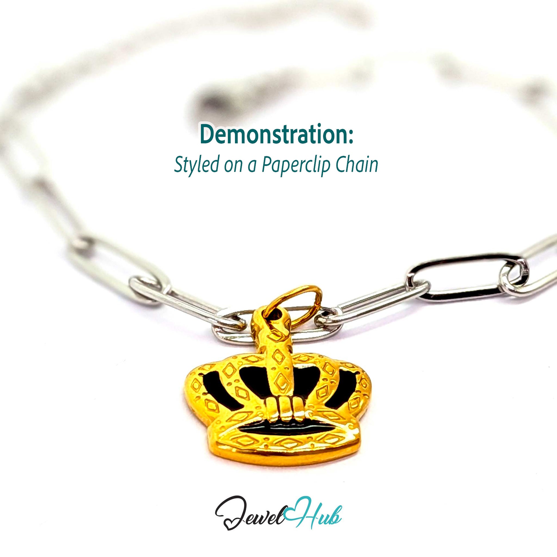 Crown charm in gold stainless steel with black enamel - styled on a silver paperclip chain bracelet - JewelHub