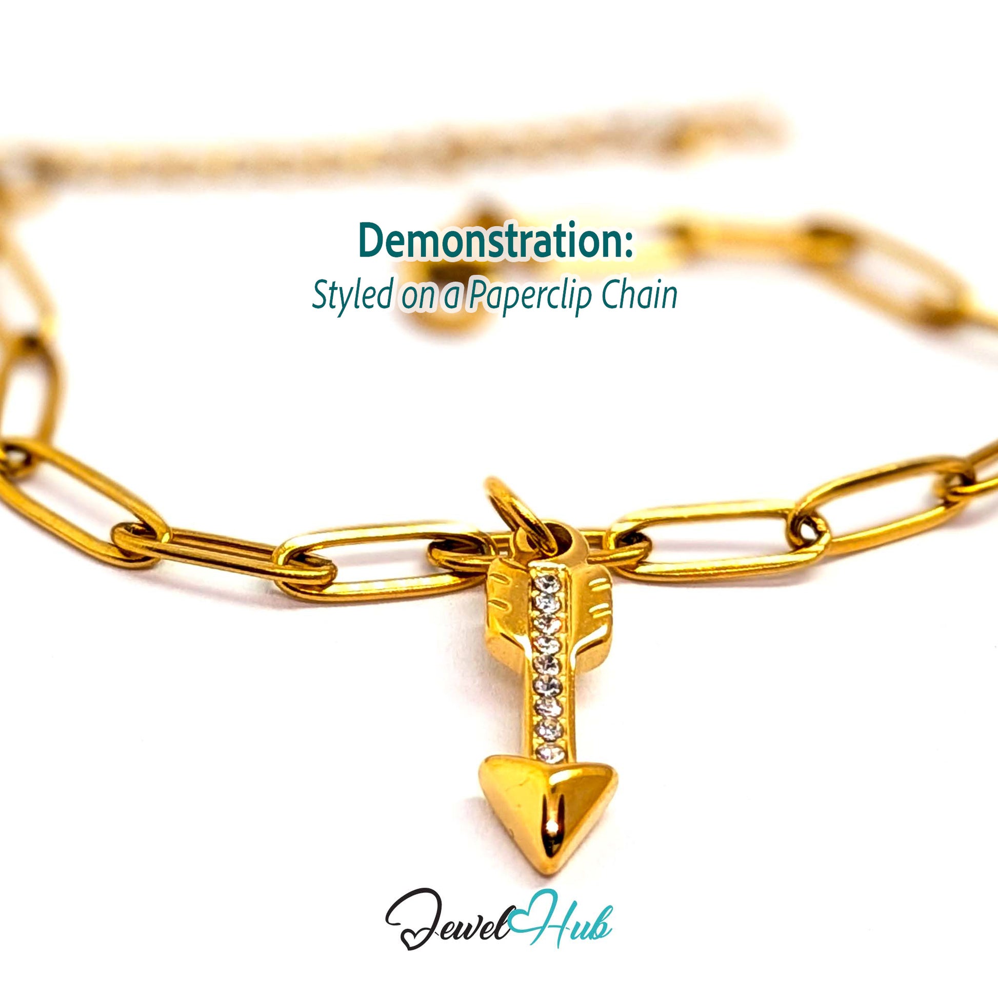Arrow charm in gold stainless steel with clear crystals - styled on a gold paperclip chain bracelet - JewelHub