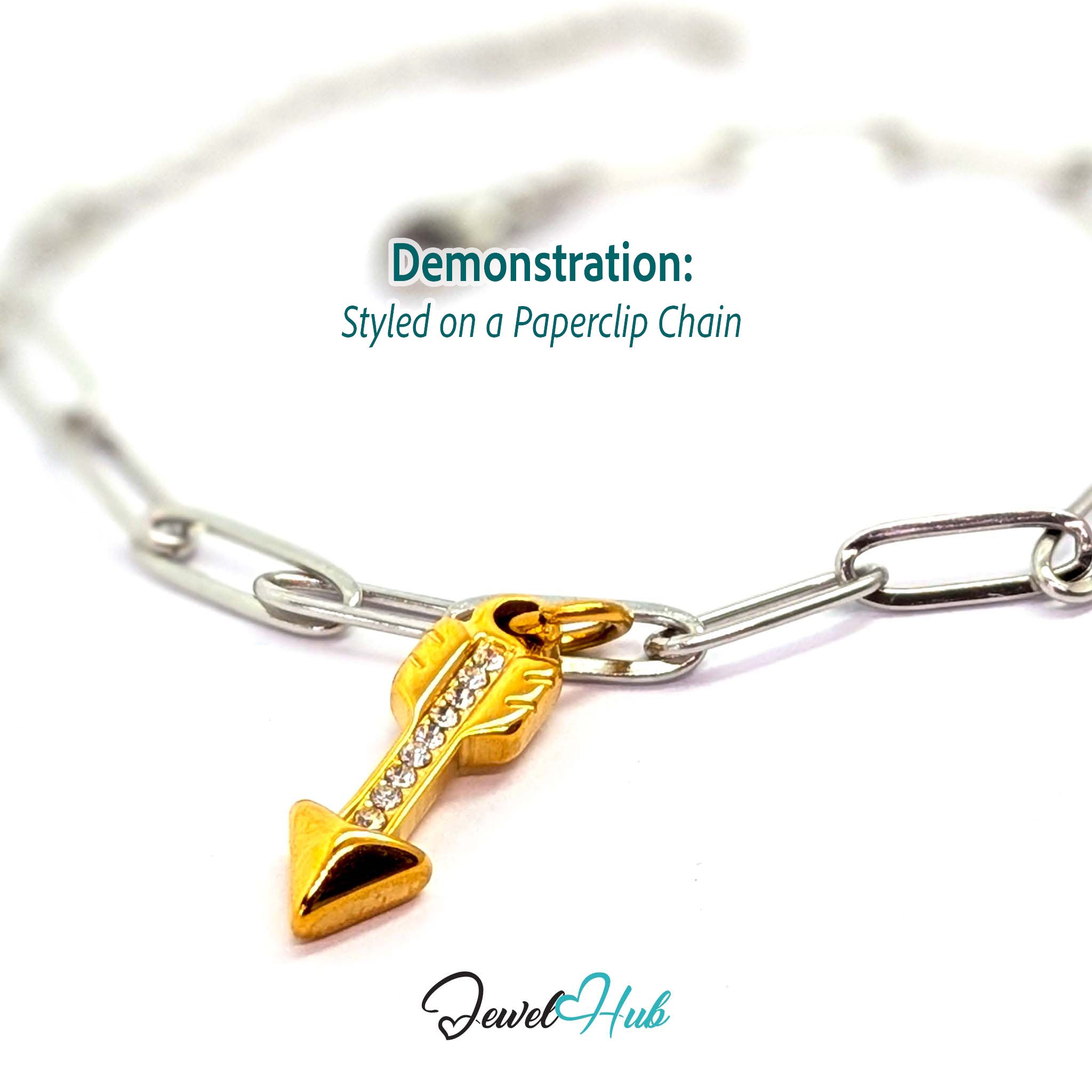 Arrow charm in gold stainless steel with clear crystals - styled on a silver paperclip chain bracelet - JewelHub