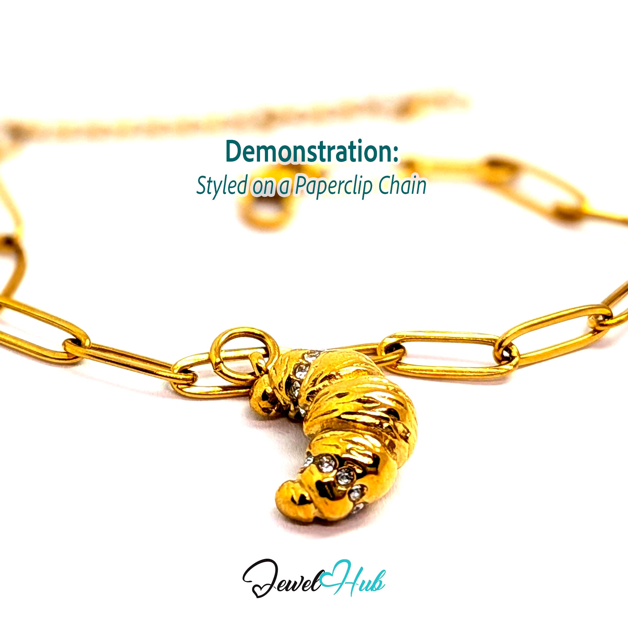 Croissant charm in gold stainless steel with clear crystals - styled on a gold paperclip chain bracelet - JewelHub