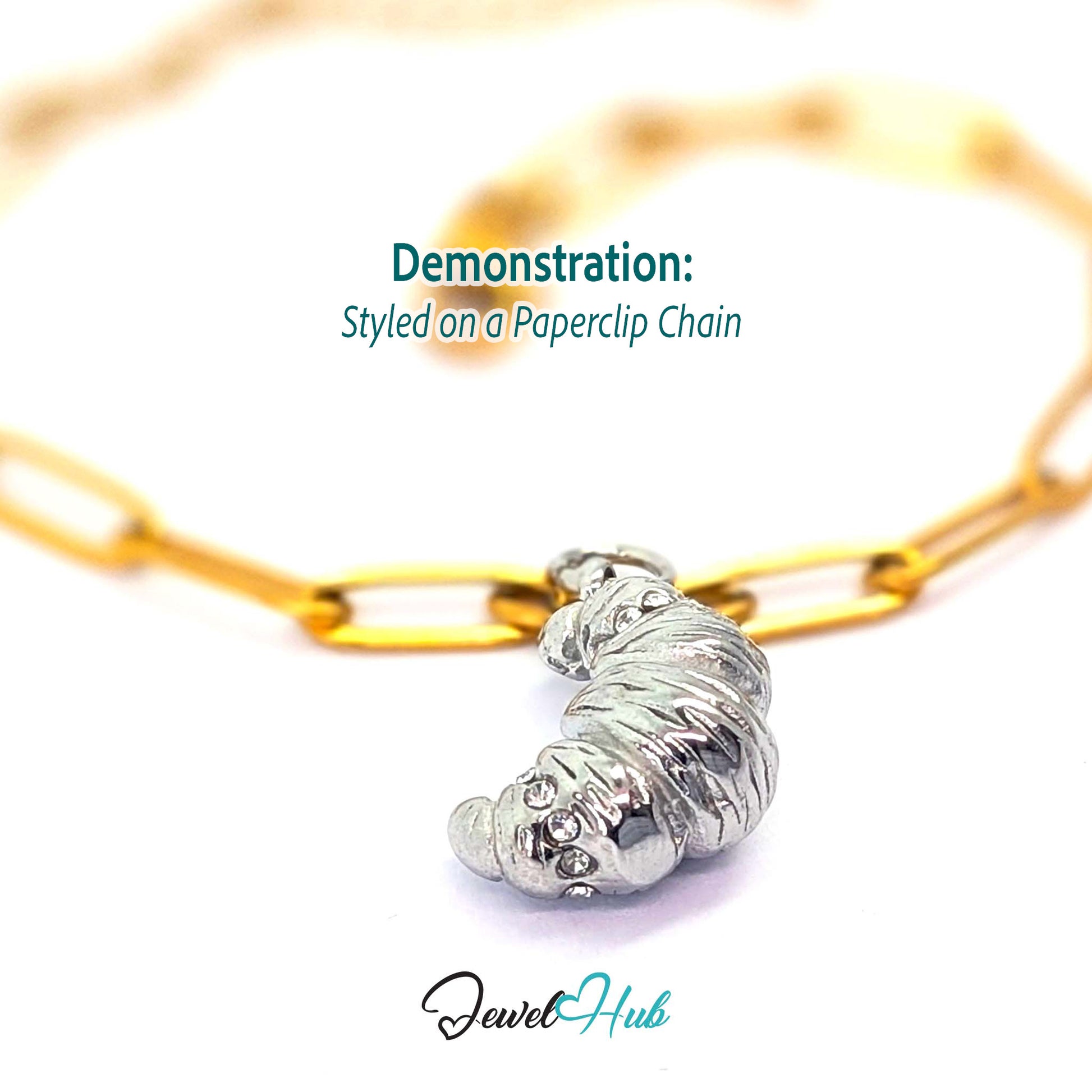Croissant charm in silver stainless steel with clear crystals - styled on a gold paperclip chain bracelet - JewelHub