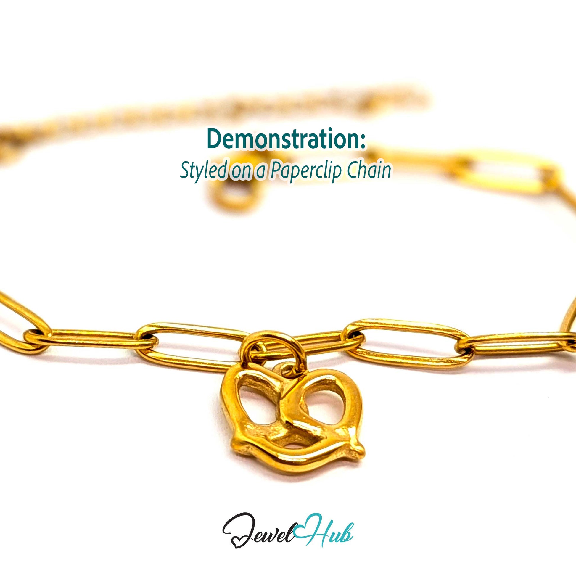 Openwork pretzel charm in gold stainless steel - styled on a gold paperclip chain bracelet - JewelHub
