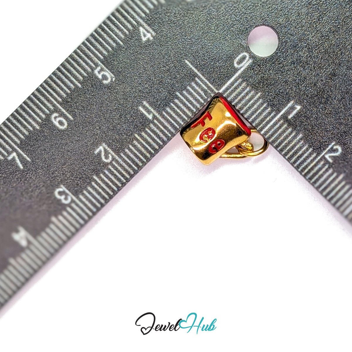 Red lettering coffee mug charm measured against a ruler at 10mm wide by 12mm tall - JewelHub