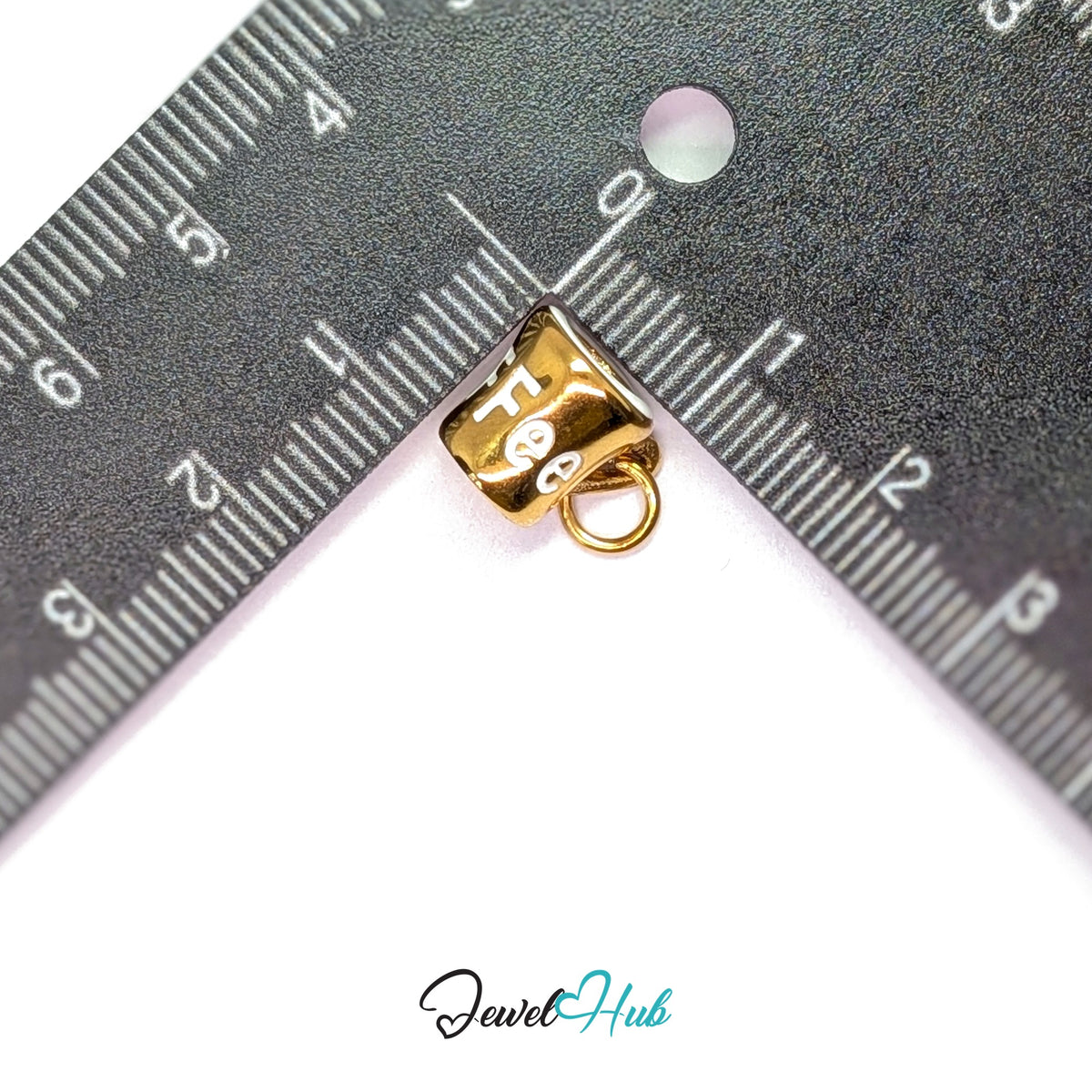 White lettering coffee mug charm measured against a ruler at 10mm wide by 12mm tall - JewelHub