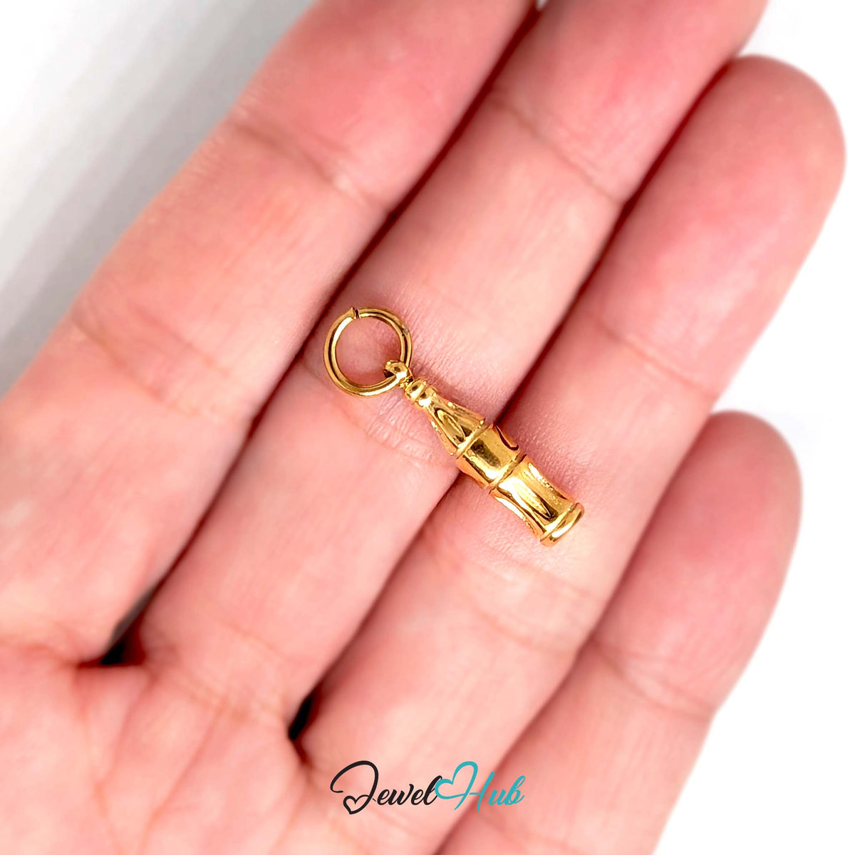 Soda bottle charm held in a hand to show its size - JewelHub