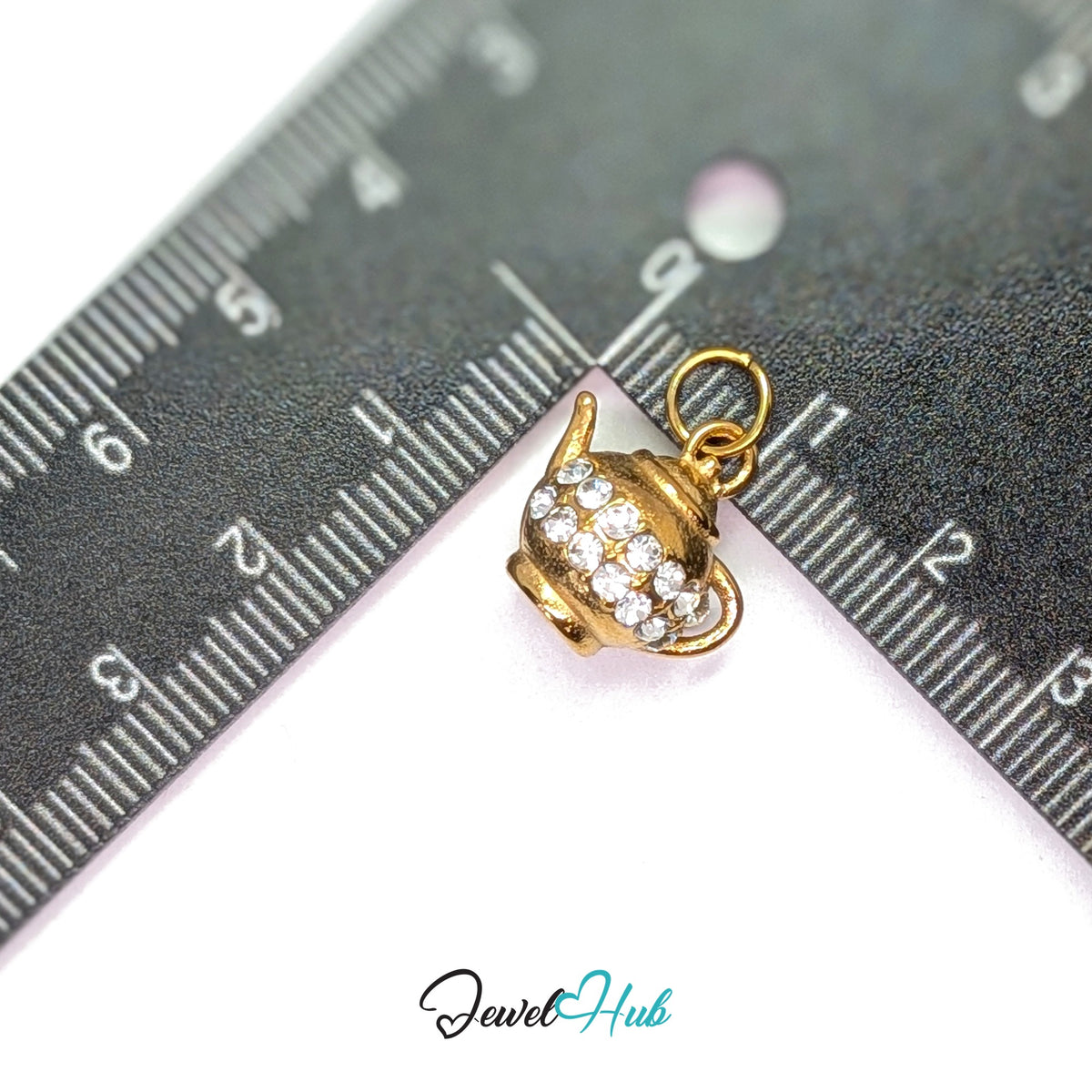 Crystal teapot charm measured against a ruler at 16mm wide by 15mm tall - JewelHub