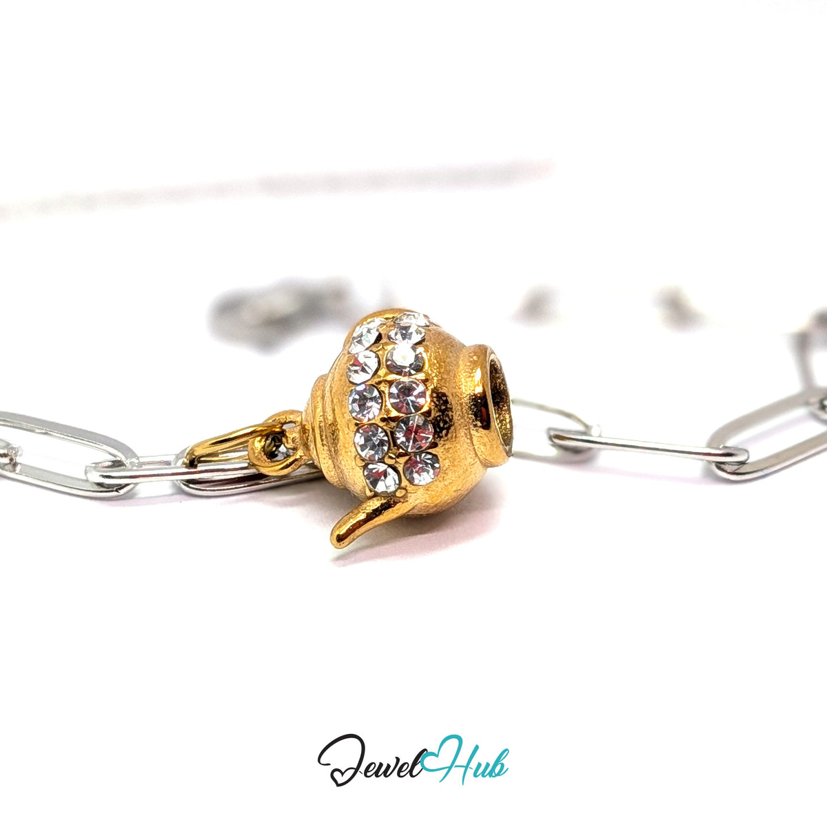 Gold-tone crystal teapot charm styled on a silver paperclip chain bracelet for a two-tone look - JewelHub