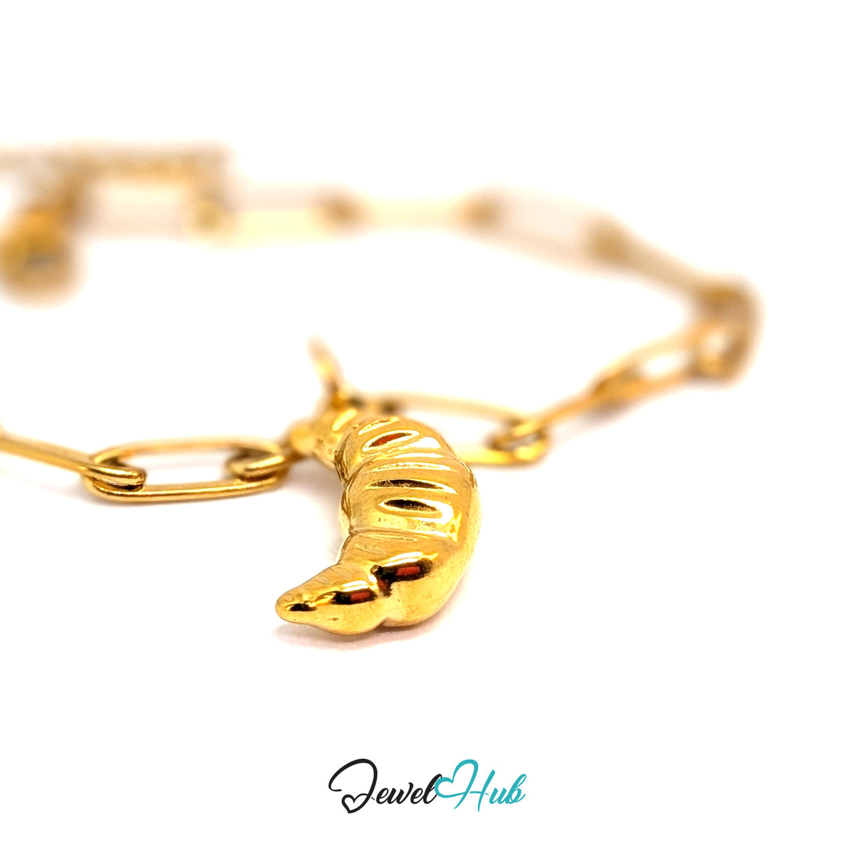 Gold-tone chunky croissant charm styled on a gold paperclip chain bracelet - JewelHub
