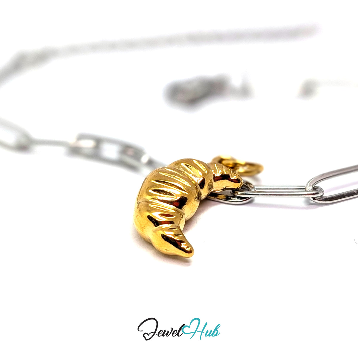 Gold-tone chunky croissant charm styled on a silver paperclip chain bracelet for a two-tone look - JewelHub