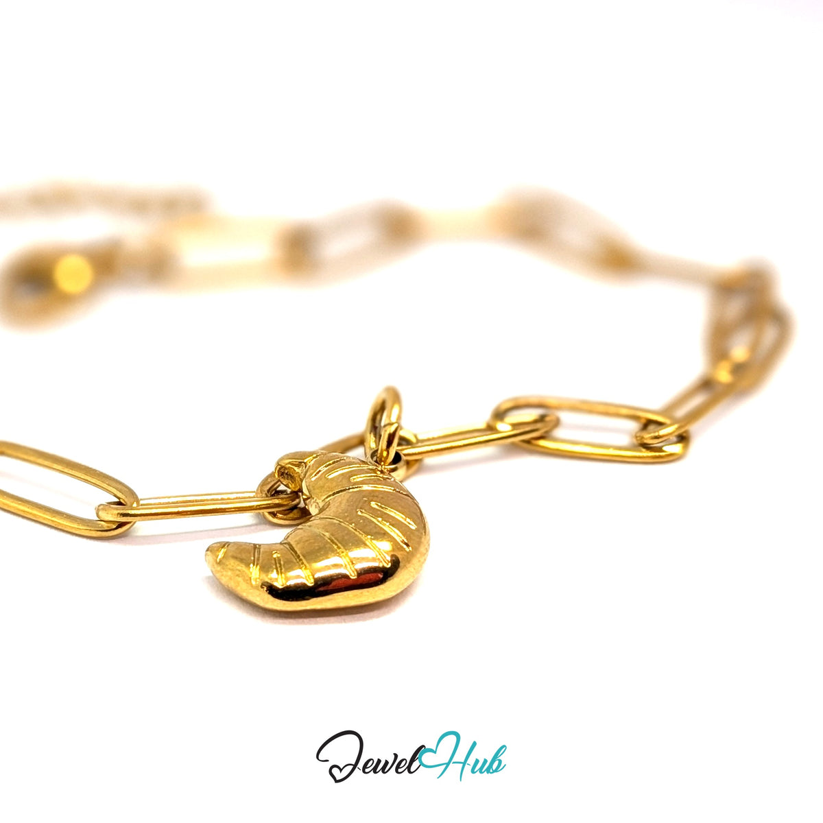 Gold-tone slim ridged croissant charm styled on a gold paperclip chain bracelet - JewelHub