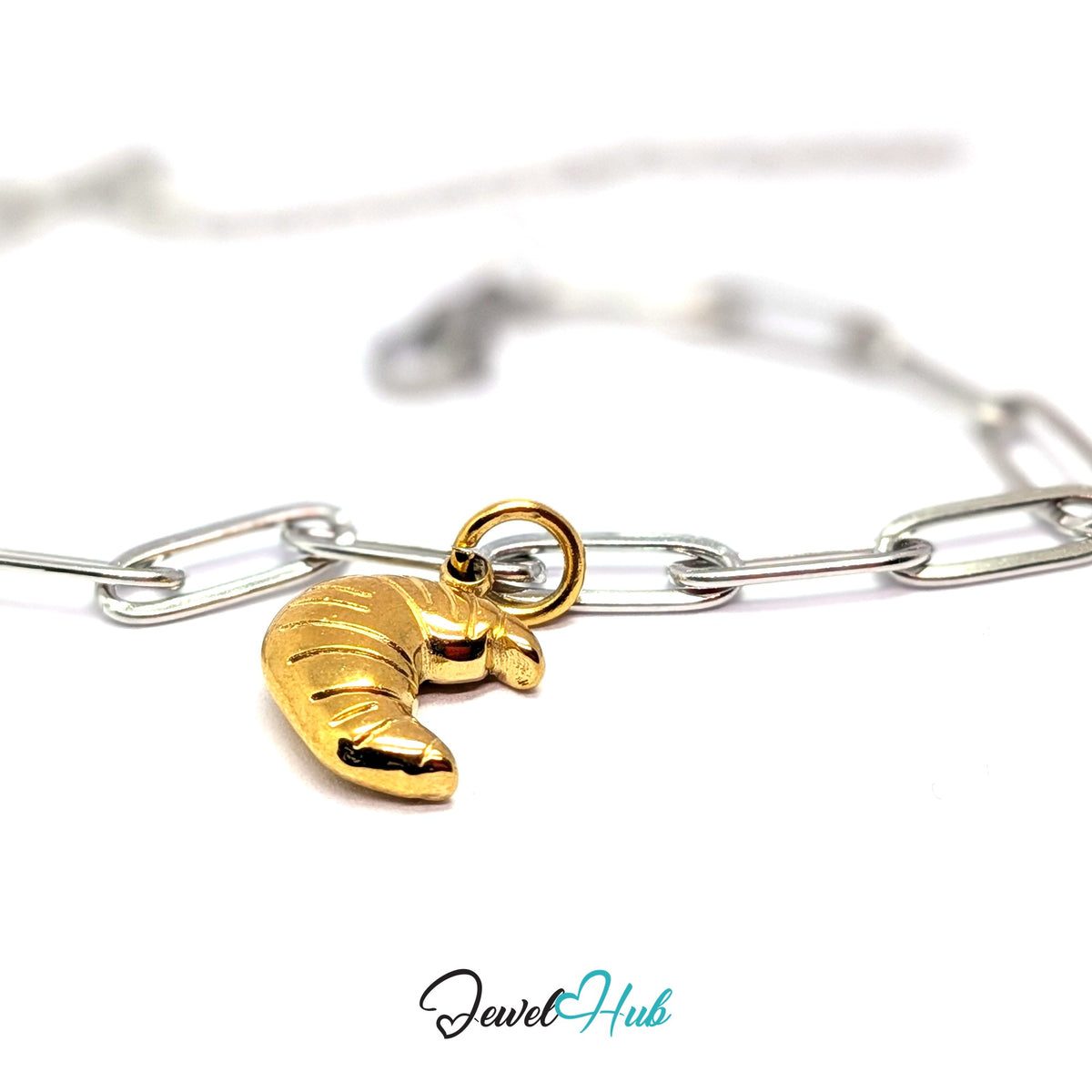 Gold-tone slim ridged croissant charm styled on a silver paperclip chain bracelet for a two-tone look - JewelHub