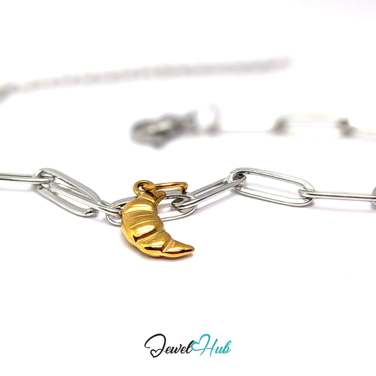 Gold-tone mini croissant charm styled on a silver paperclip chain bracelet for a two-tone look - JewelHub