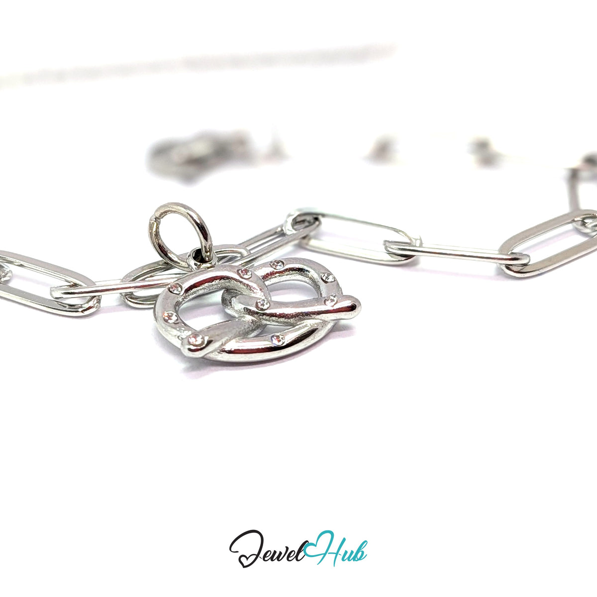 Silver-tone pretzel charm styled on a silver paperclip chain bracelet - JewelHub