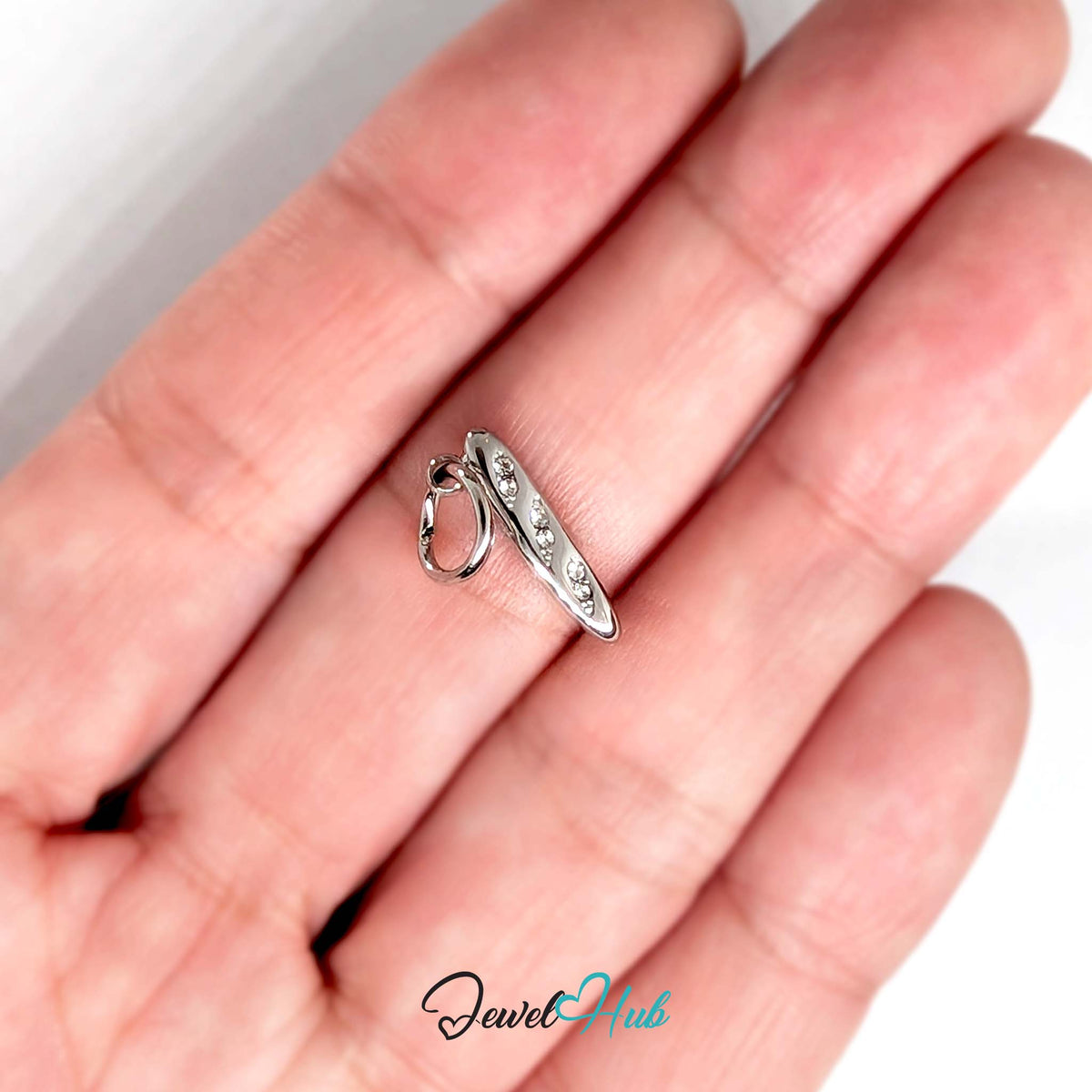 Crystal baguette charm held in a hand to show its size - JewelHub