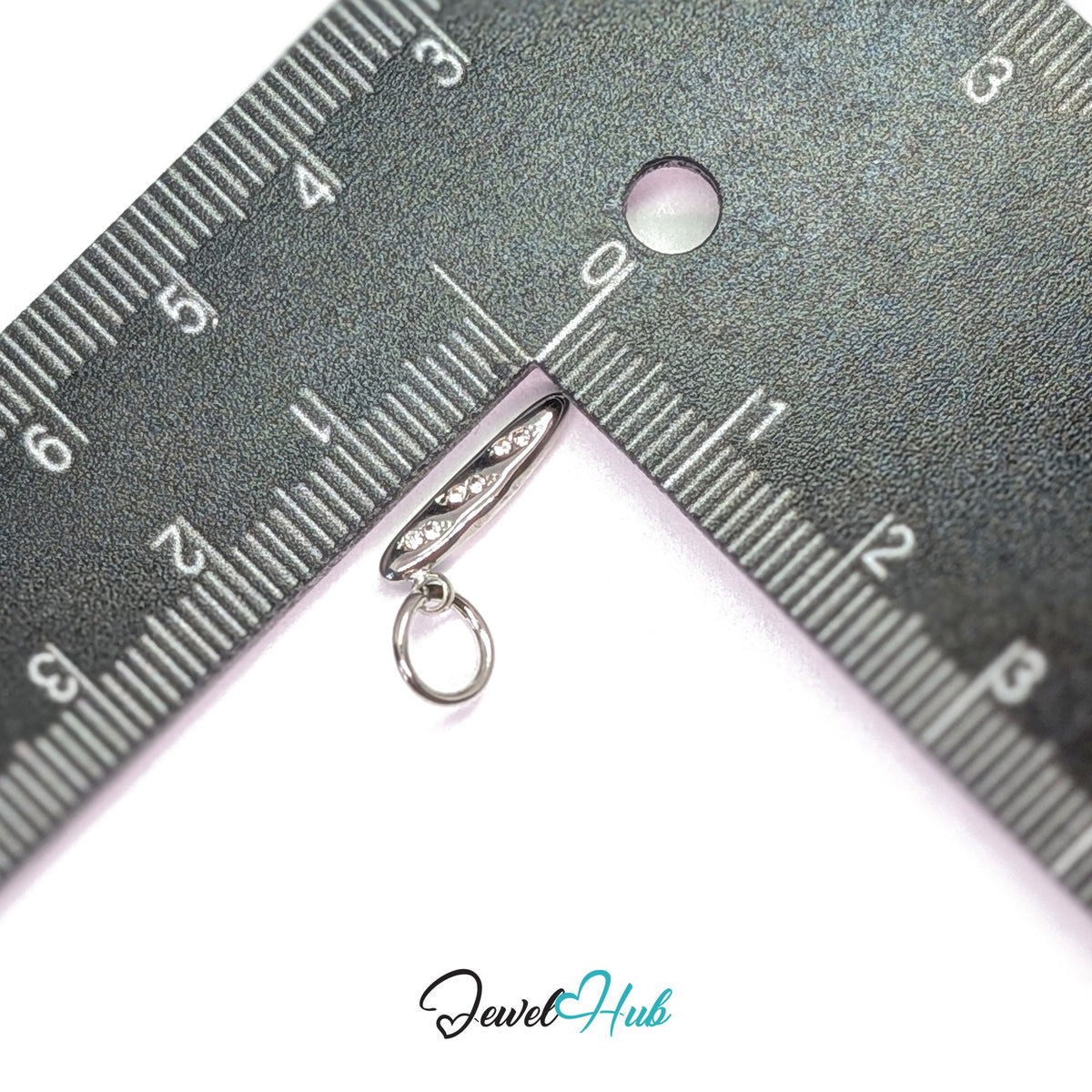 Crystal baguette charm measured against a ruler at 3.3mm wide by 15mm tall - JewelHub