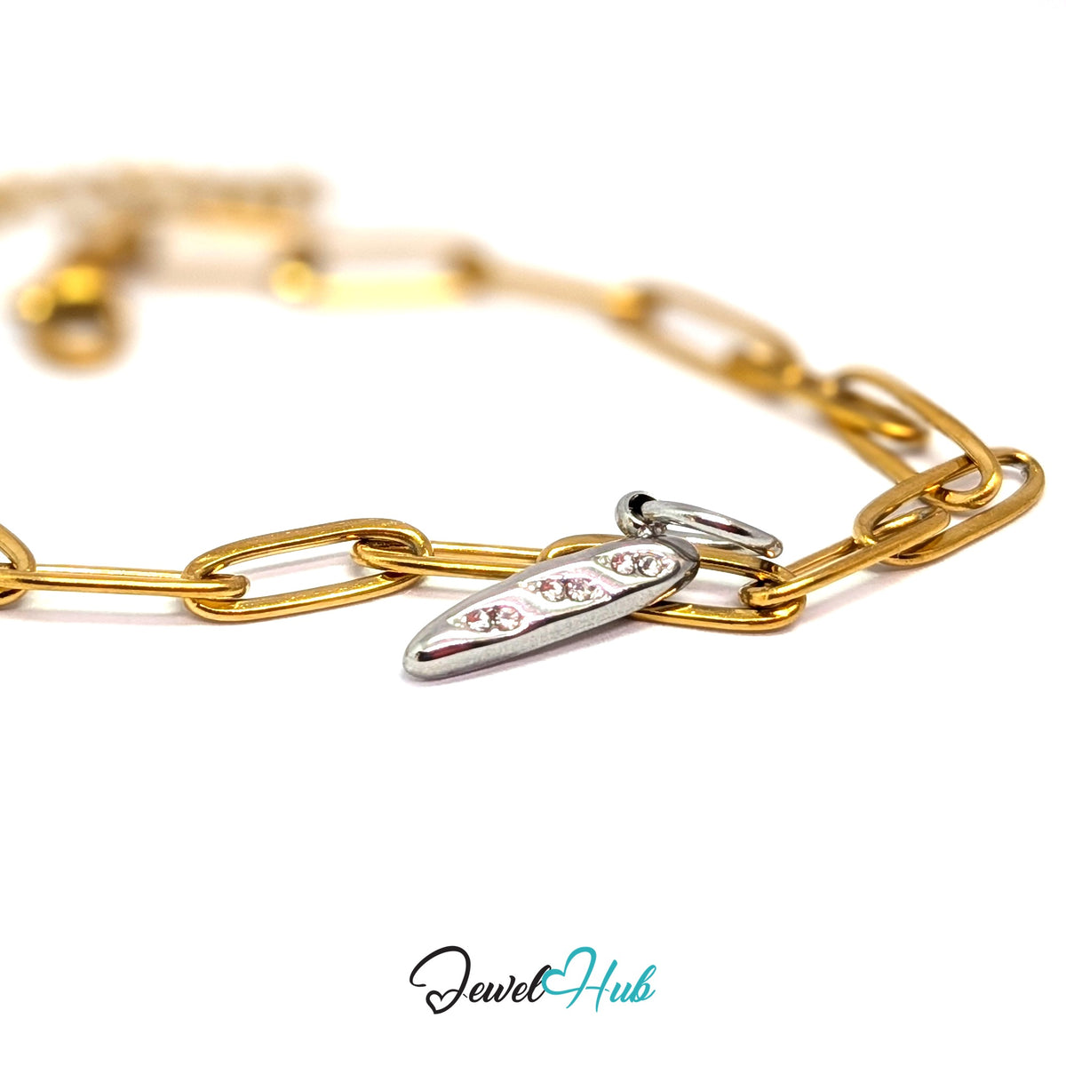Silver-tone crystal baguette charm styled on a gold paperclip chain bracelet for a two-tone look - JewelHub