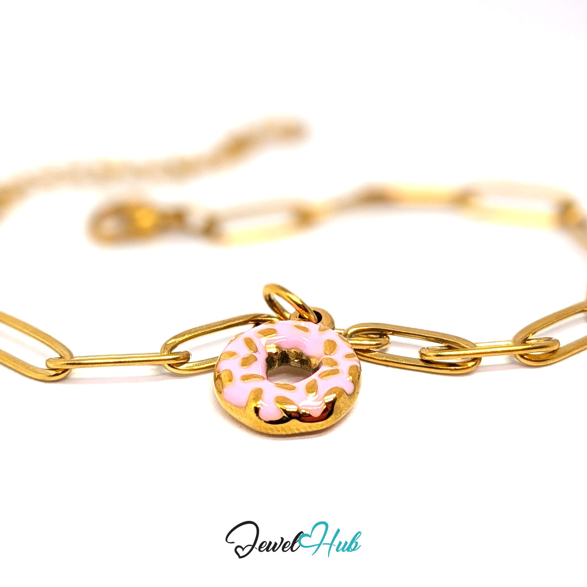 Gold-tone pink sprinkle donut charm styled on a gold paperclip chain bracelet - JewelHub