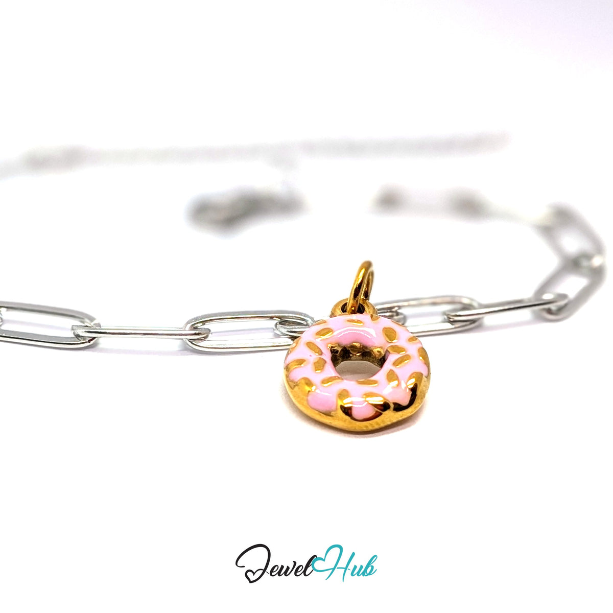 Gold-tone pink sprinkle donut charm styled on a silver paperclip chain bracelet for a two-tone look - JewelHub