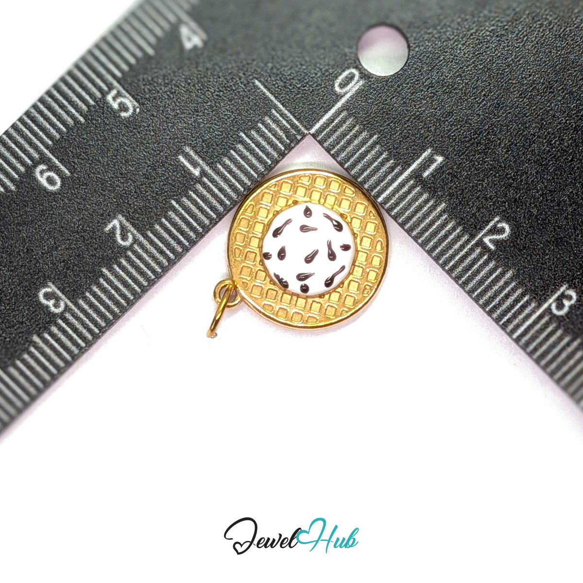 Cookies and cream waffle charm measured against a ruler at 17.1mm wide by 19.8mm tall - JewelHub