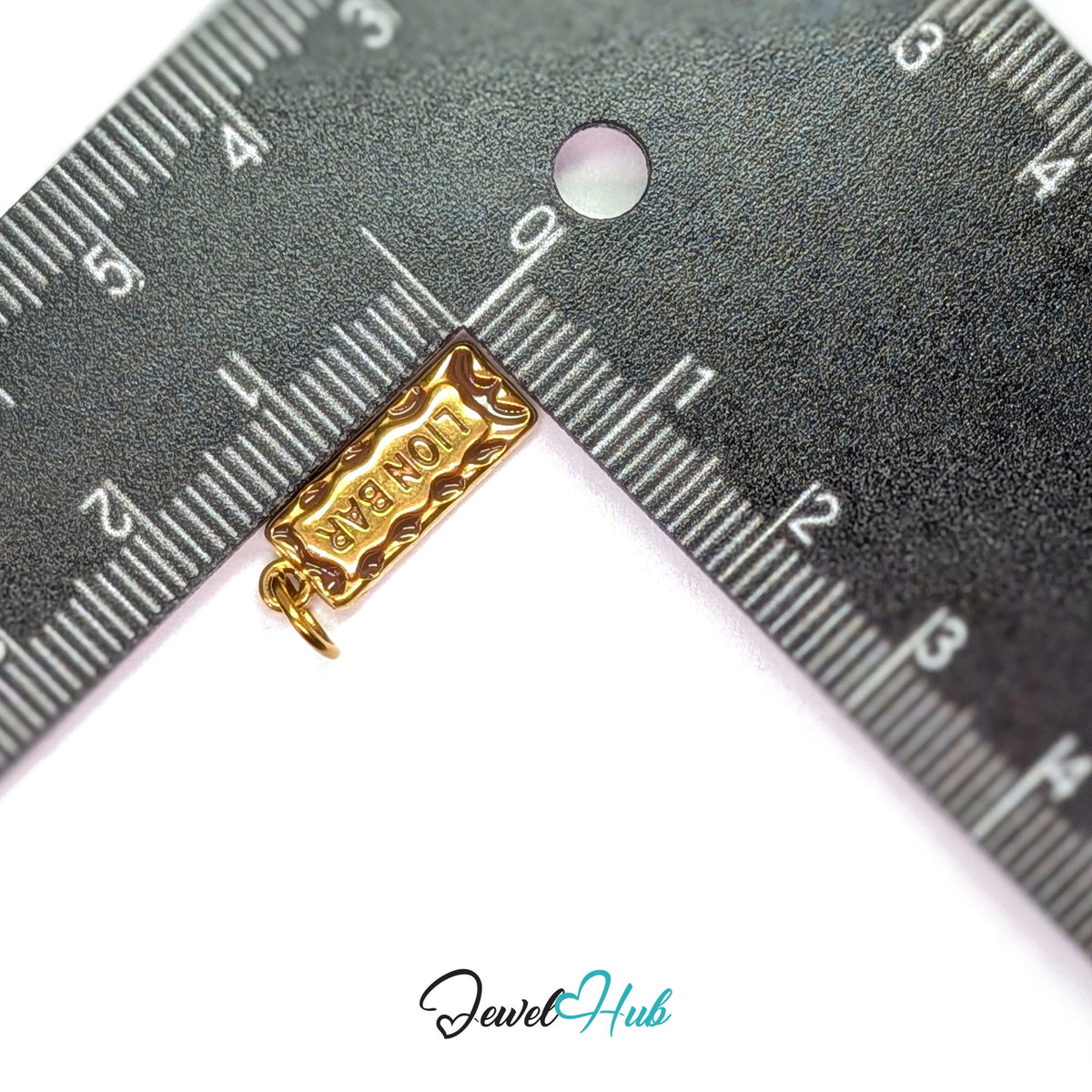 Chocolate bar charm measured against a ruler at 6.8mm wide by 18.6mm tall - JewelHub