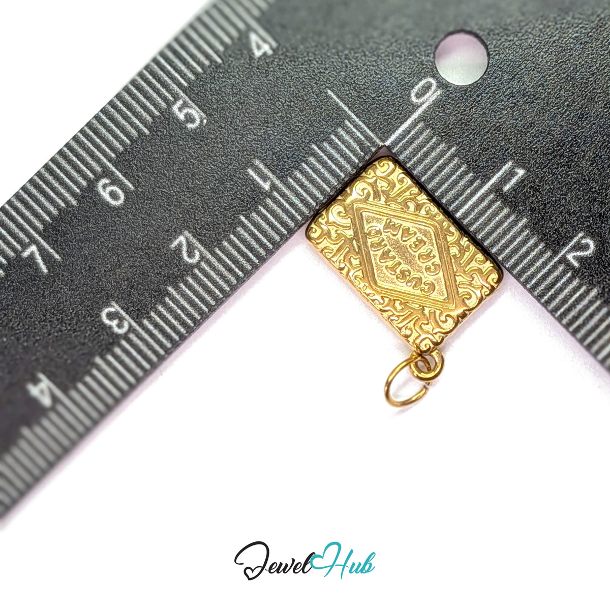 Custard cream biscuit charm measured against a ruler at 14mm wide by 20.3mm tall - JewelHub